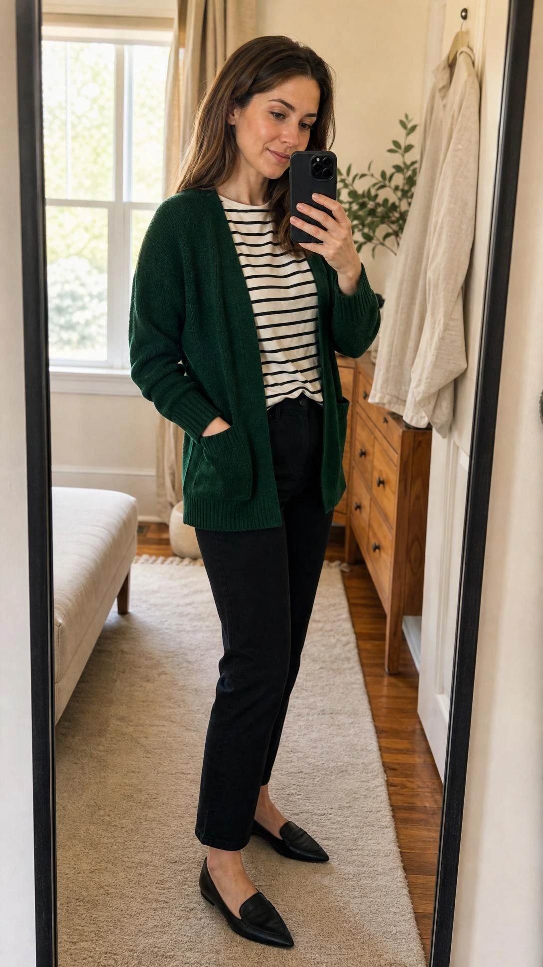 Dark green cardigan layered over a striped tee in a warm bedroom mirror selfie, showing a flattering casual green cardigan outfit from head to toe.
