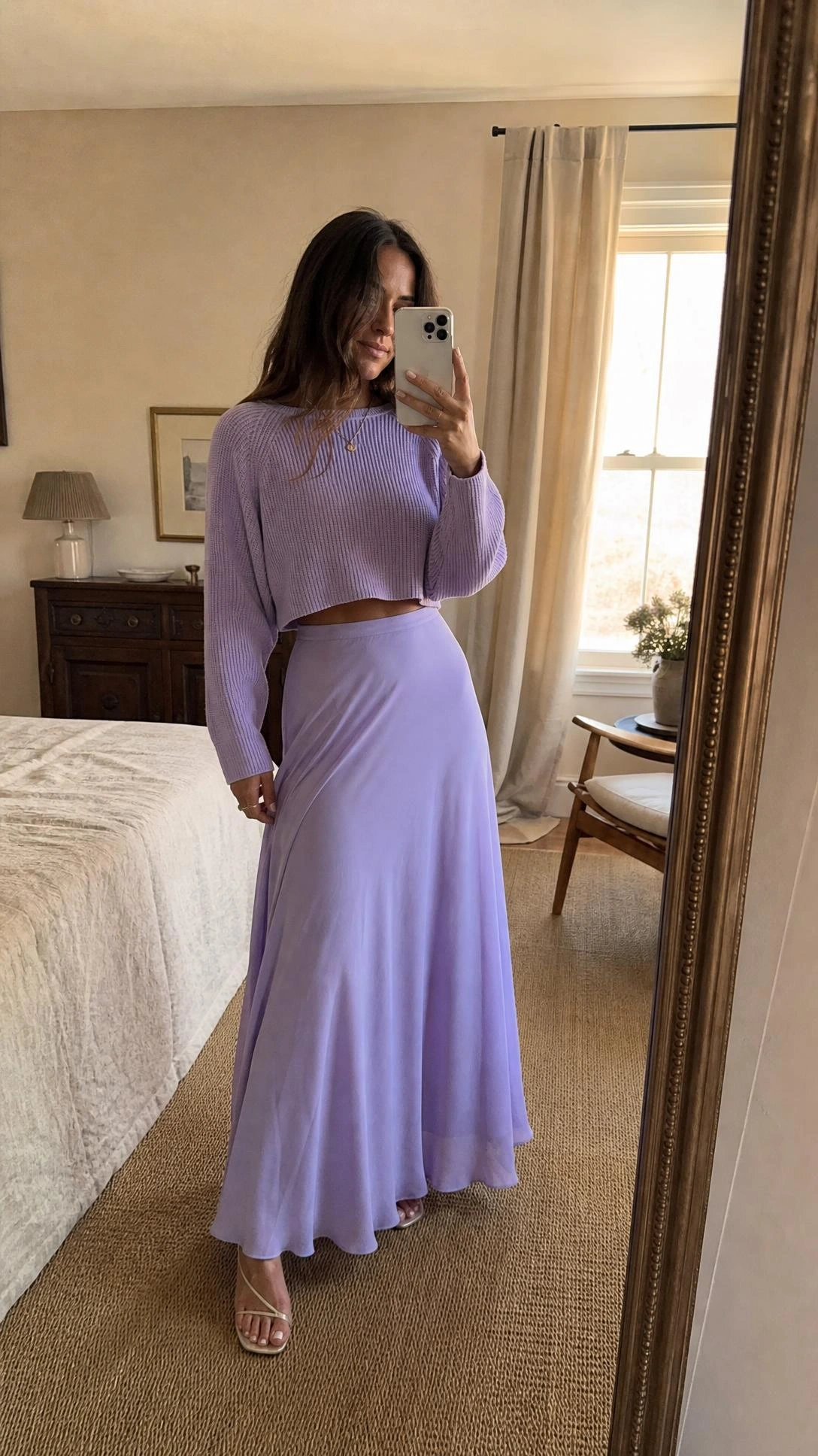 Woman in pastel lavender maxi skirt and matching fine-knit crop top takes mirror selfie, showing a monochromatic summer maxi skirt outfit