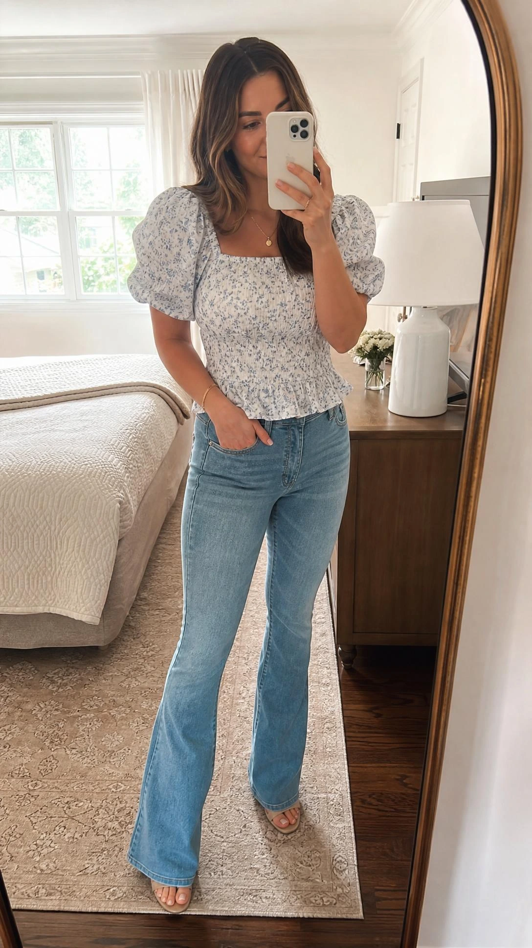 Pear shape outfit idea with a puff sleeve blouse tucked into flattering mid-rise bootcut denim, shown in a sunlit bedroom mirror selfie.