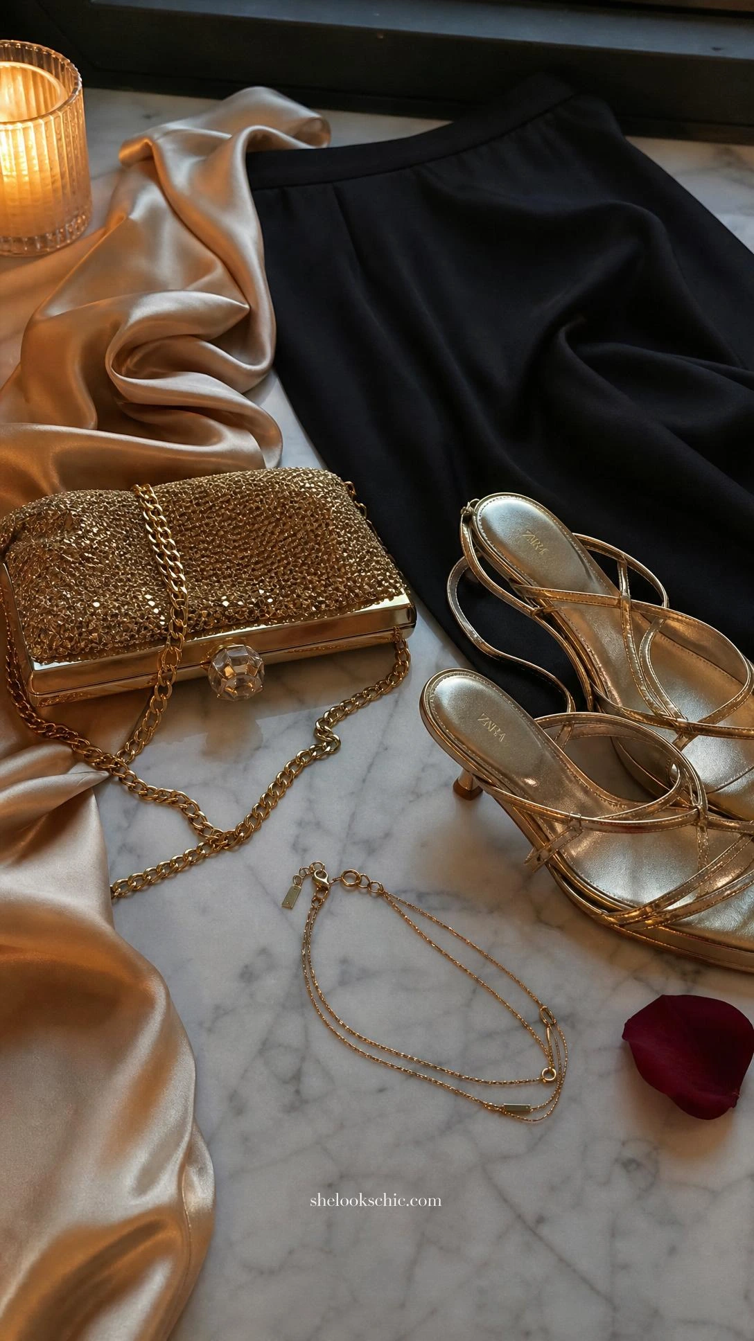 Champagne gold silk camisole draped beside a delicate gold chain necklace, styled details for an elegant black maxi skirt evening outfit