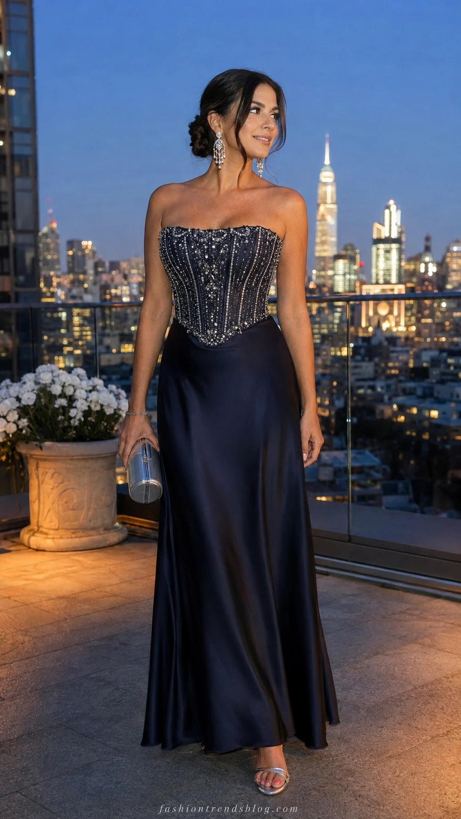 Woman in floor-length midnight navy beaded corset dress on rooftop terrace at blue hour, embodying a showstopping big birthday outfit