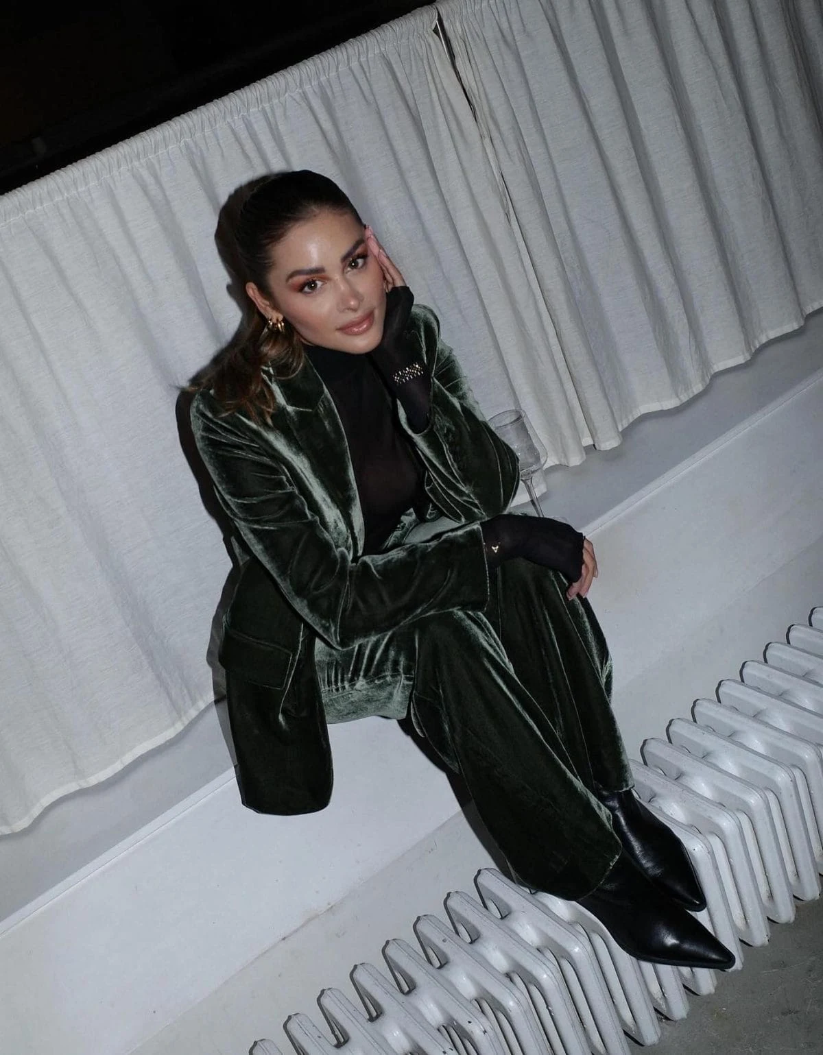 Forest green velvet suit styled with a black top and black boots for a concert.