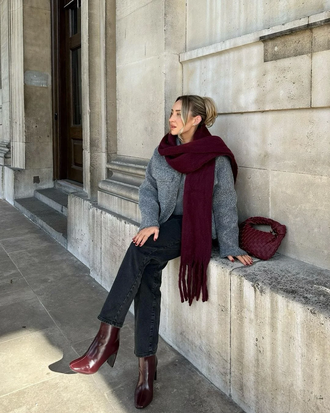Featuring a gray textured jacket and black jeans, this look is elevated with burgundy ankle boots and a matching scarf. Perfect for casual outings in winter, this outfit blends warmth with sophistication.