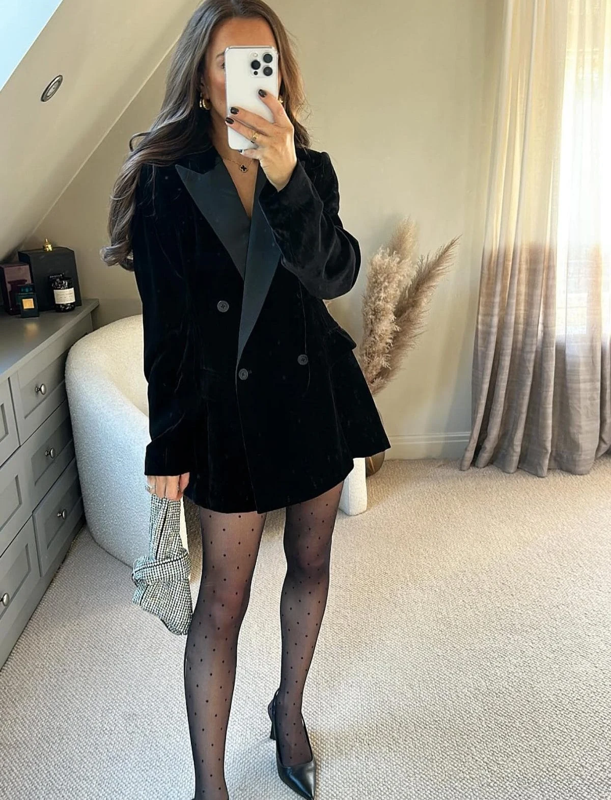 Black velvet double-breasted blazer worn with sheer spotted tights and black slingback heels.