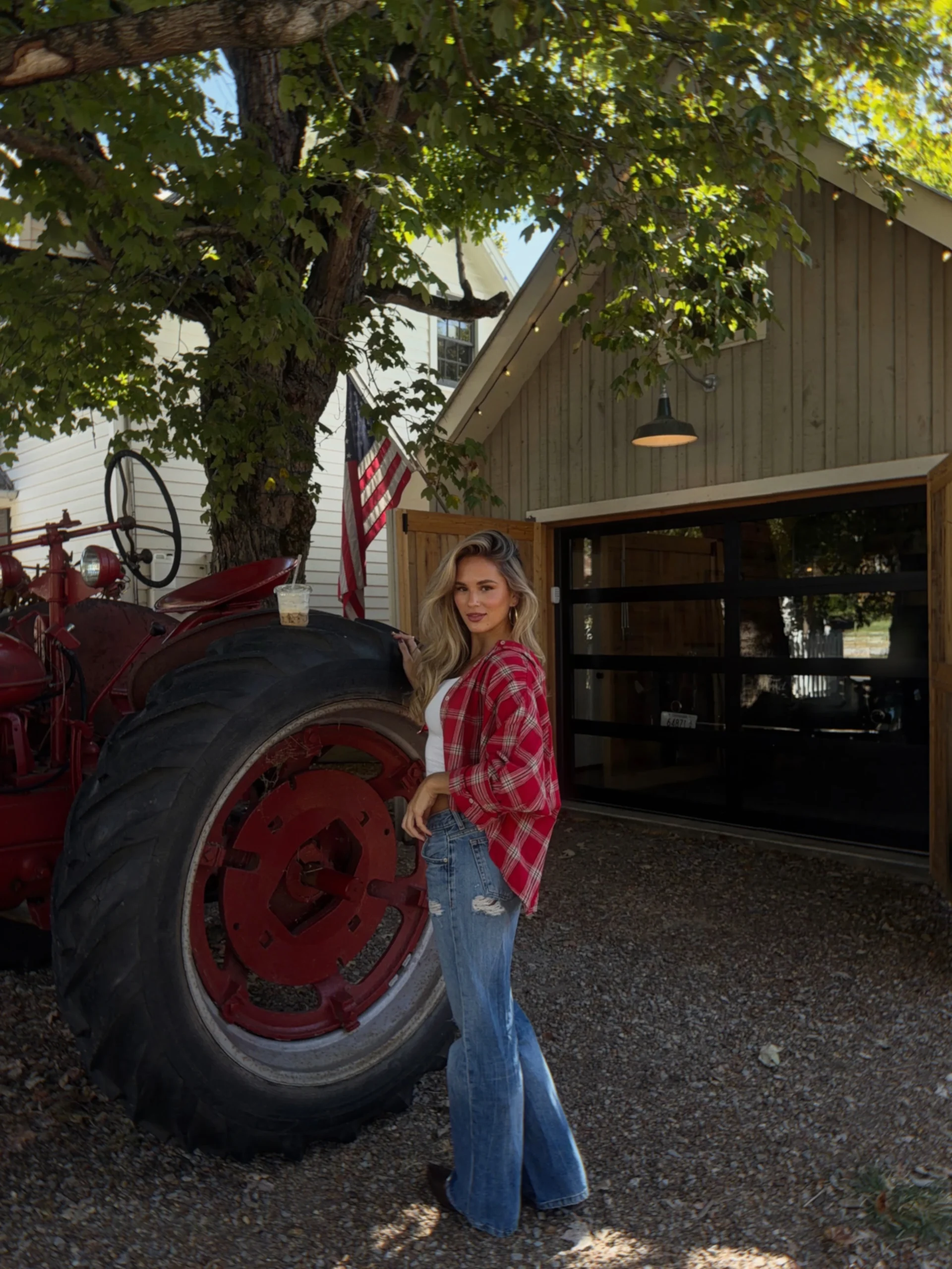 White ribbed tank, open red plaid flannel, light-wash wide-leg jeans, and brown boots fall outfit.