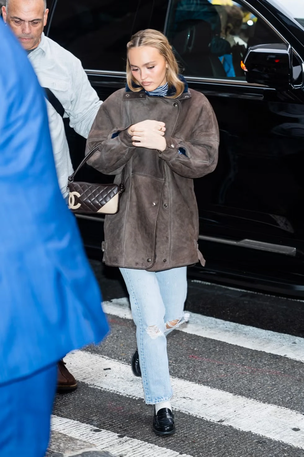 Lily-Rose Depp in Midtown Manhattan wearing a shearling coat and slim trousers in December.