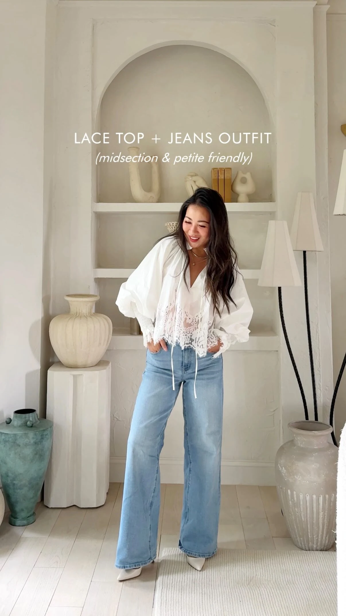 White voluminous lace-detailed blouse styled with light-wash wide-leg denim jeans.