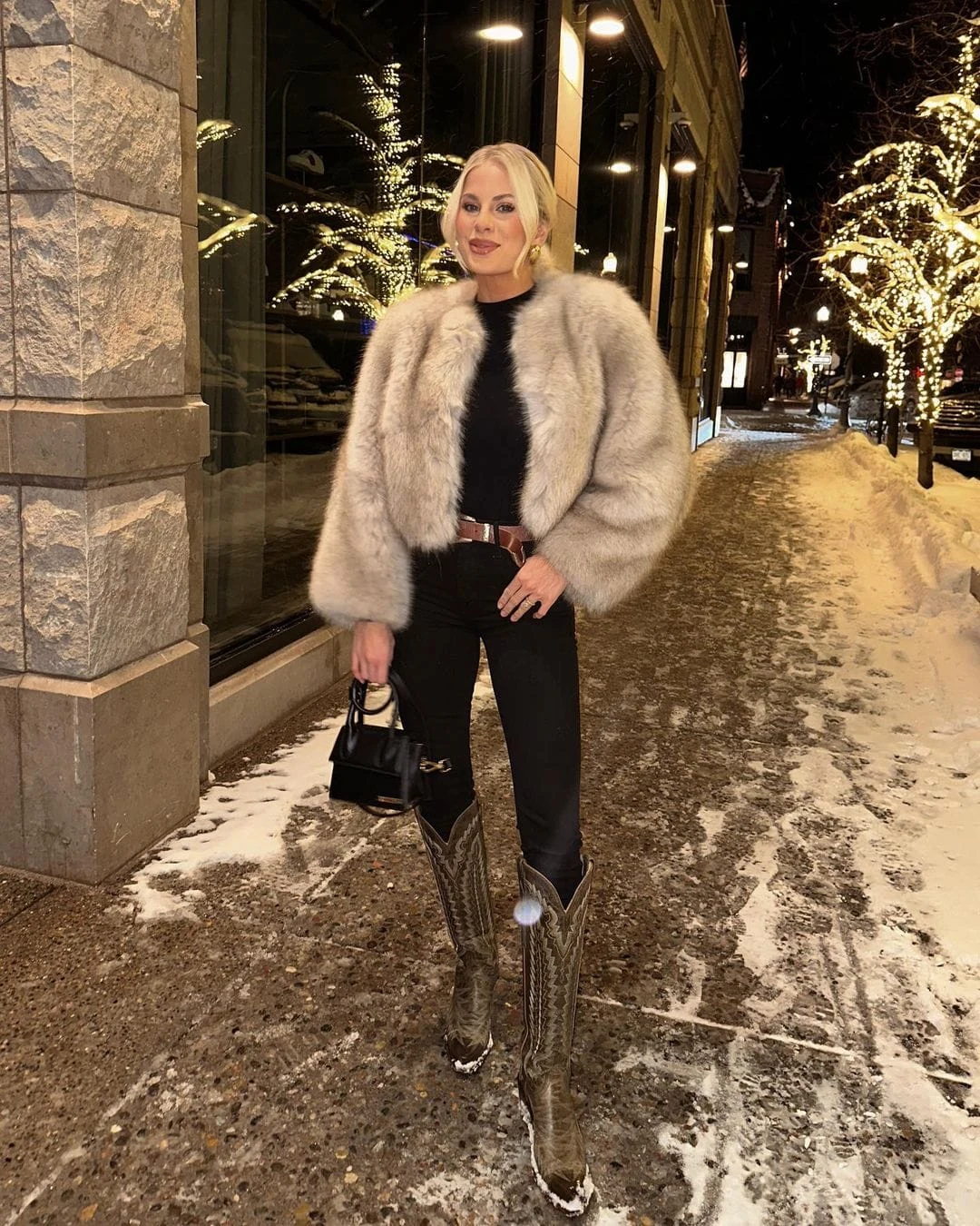 Elevate an all-black ensemble with a luxe fur jacket and edgy cowboy boots. It’s the perfect mix of sophistication and Western charm, ideal for nights out in the city. Finish the outfit with silver jewelry to add a touch of glamour. Recreate This Look