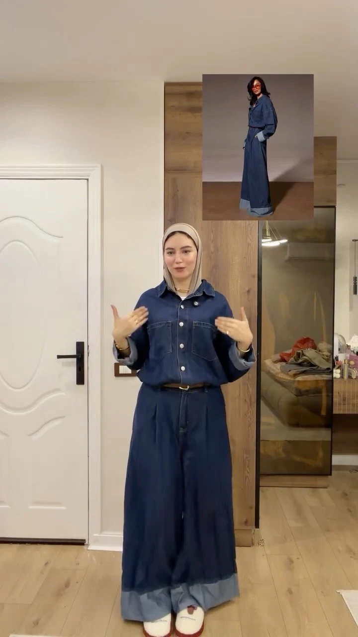Dark blue denim shirt and wide-leg jeans with a narrow belt and white shoes with red trim.