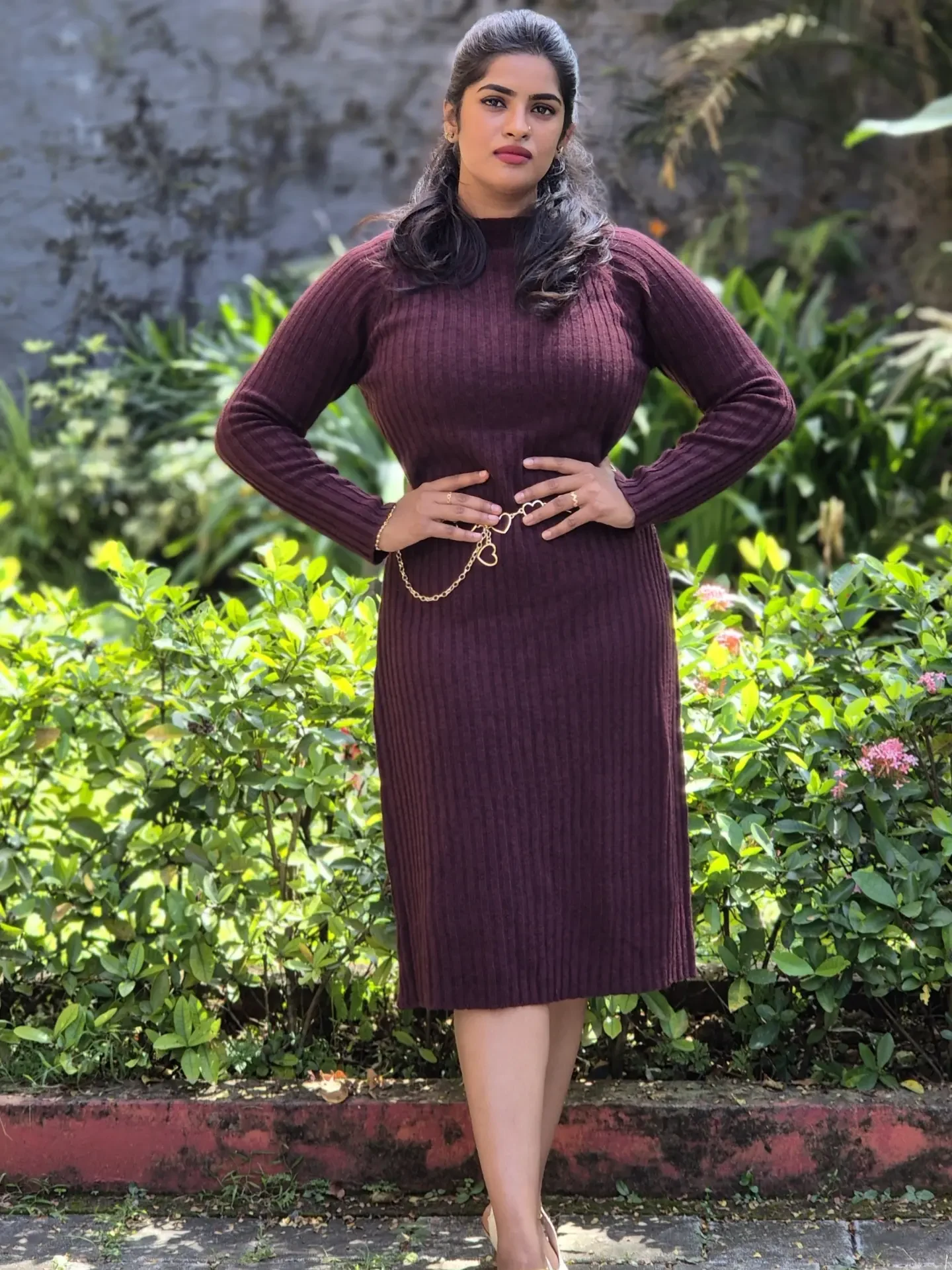 Dark burgundy ribbed long-sleeve midi dress cinched with a gold-tone chain belt at the waist.