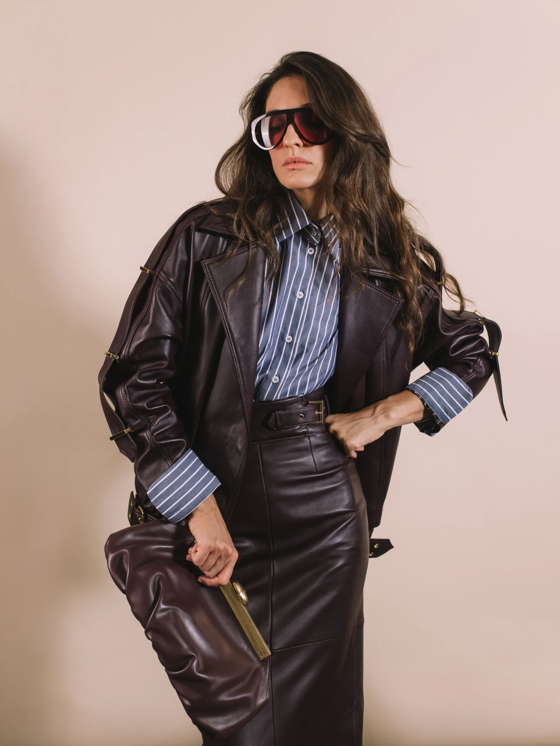 Plum leather oversized moto jacket paired with a matching plum leather mini skirt.