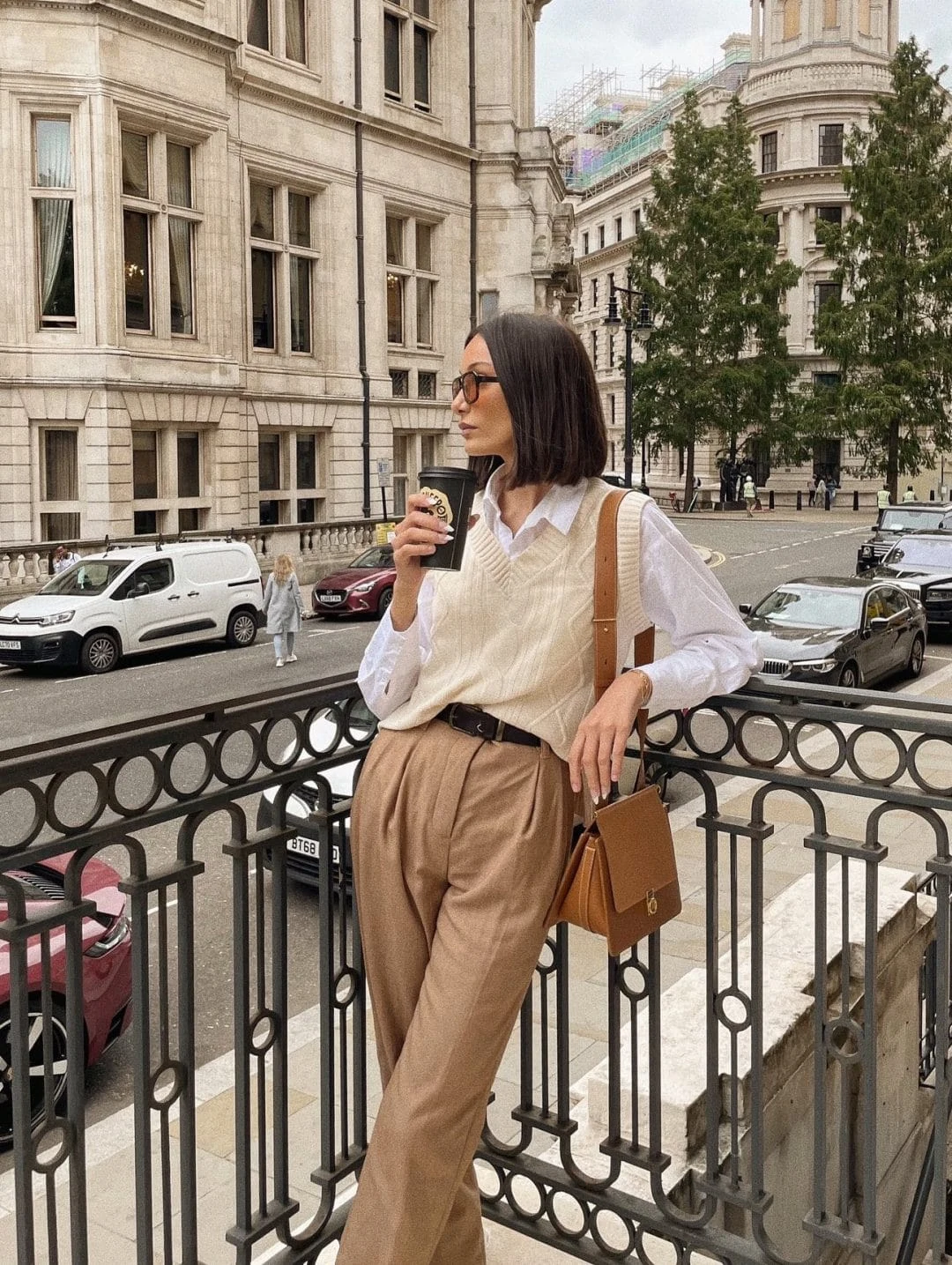 A sweater vest paired with tailored trousers for a polished, professional office-ready outfit.