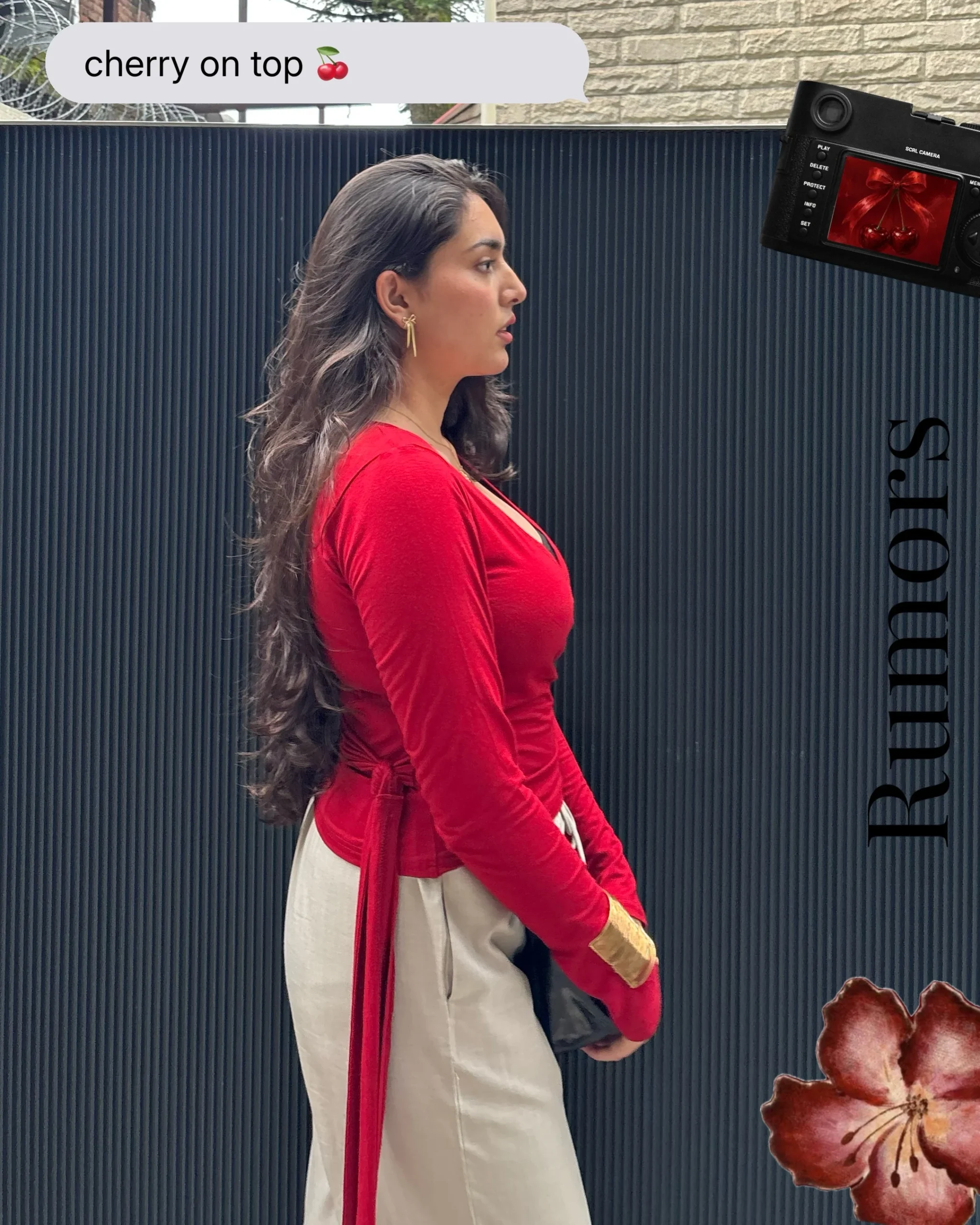 Person in a fitted red long-sleeve wrap top and high-waisted cream trousers seen from the side.