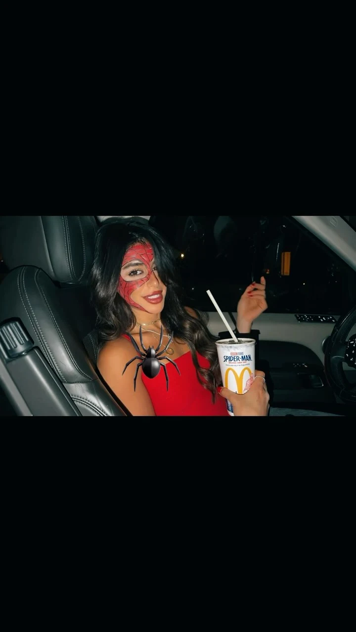 Sleeveless red top with a sweetheart neckline styled as a bold Halloween outfit choice.