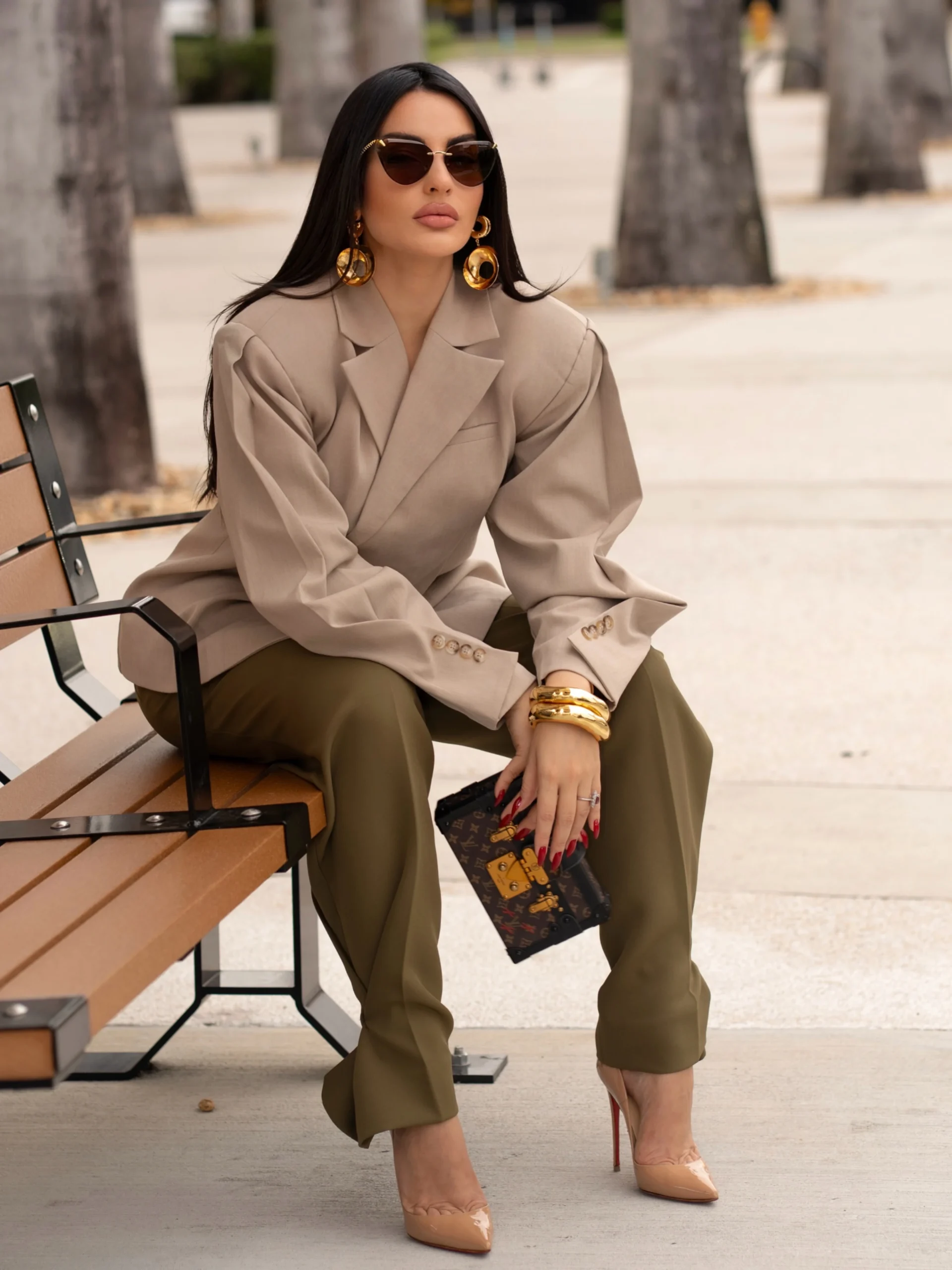 Loose beige blazer styled with cropped olive-green trousers and nude pointed-toe heels.