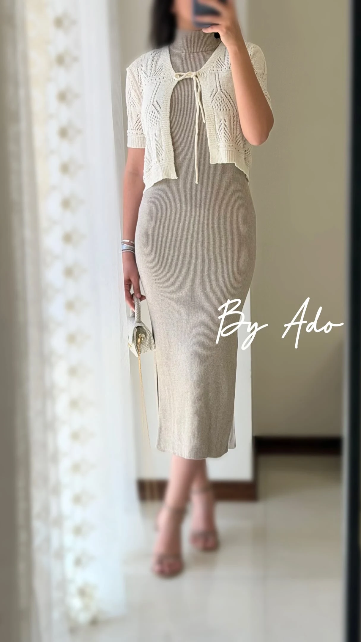 Beige ribbed midi dress layered under a cropped white openwork cardigan with light heels and handbag.