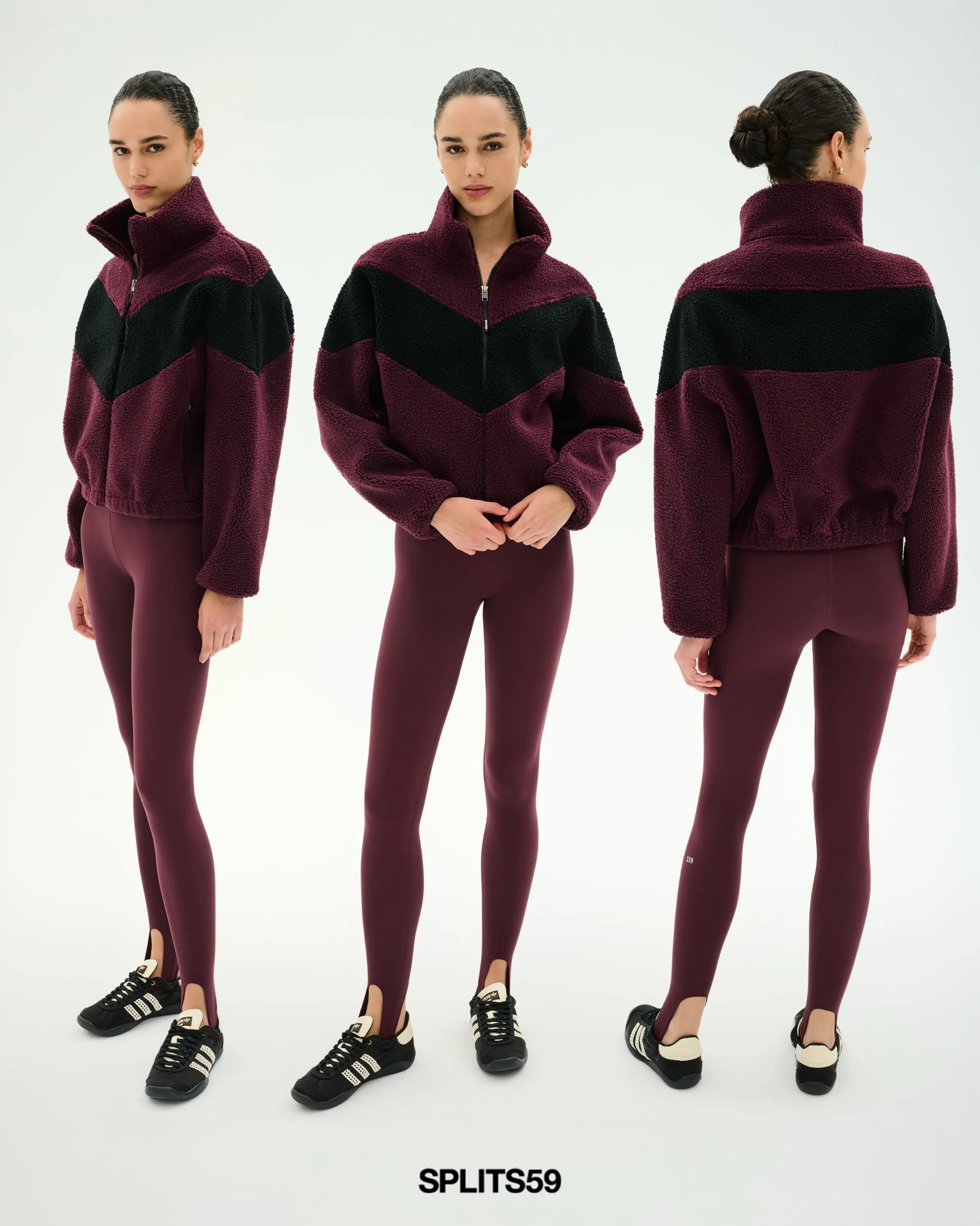 Person wearing a cropped burgundy jacket with black chevron panel and matching fitted leggings.