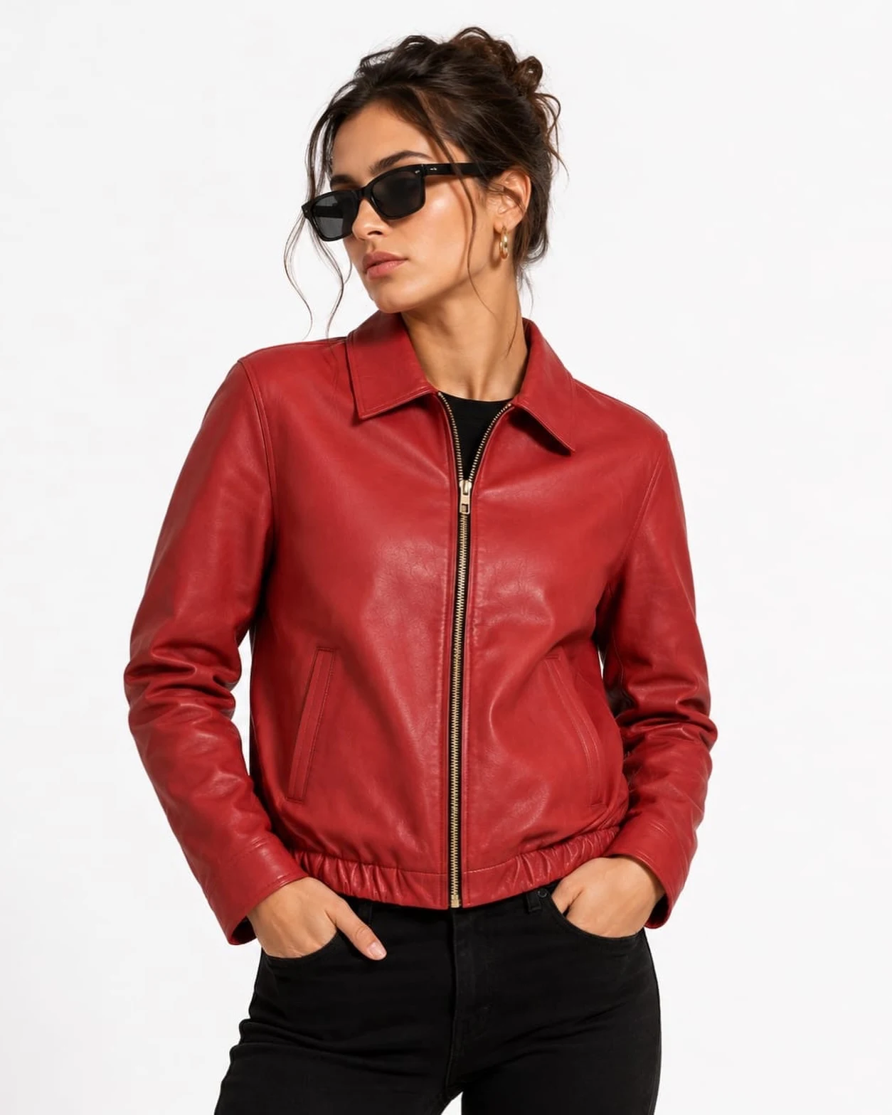 glossy bright red cropped bomber jacket partially unzipped over white top, light-wash denim jeans, black rectangular sunglasses