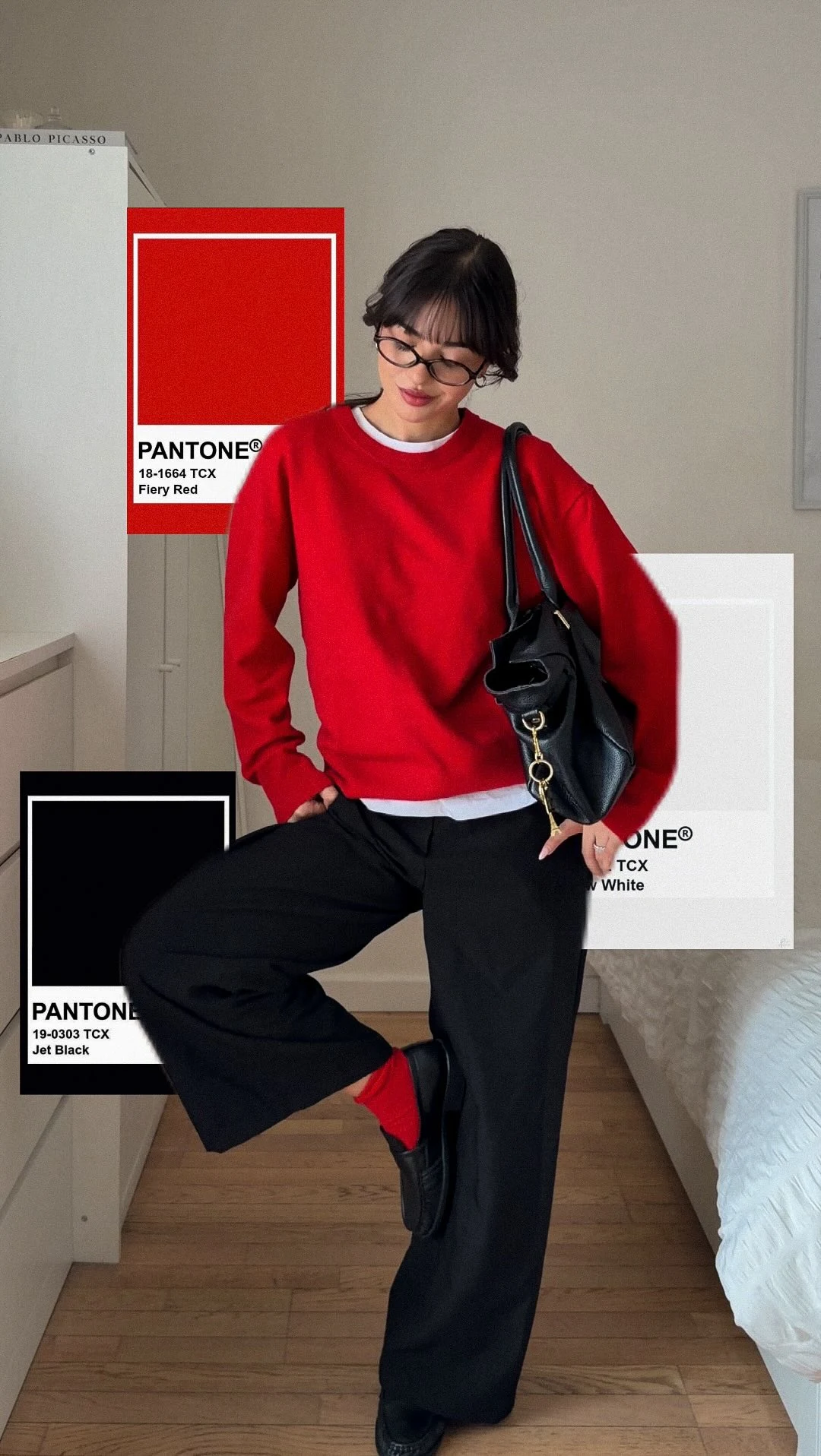 Red crewneck sweater layered over a white shirt with black wide-leg trousers and red socks.