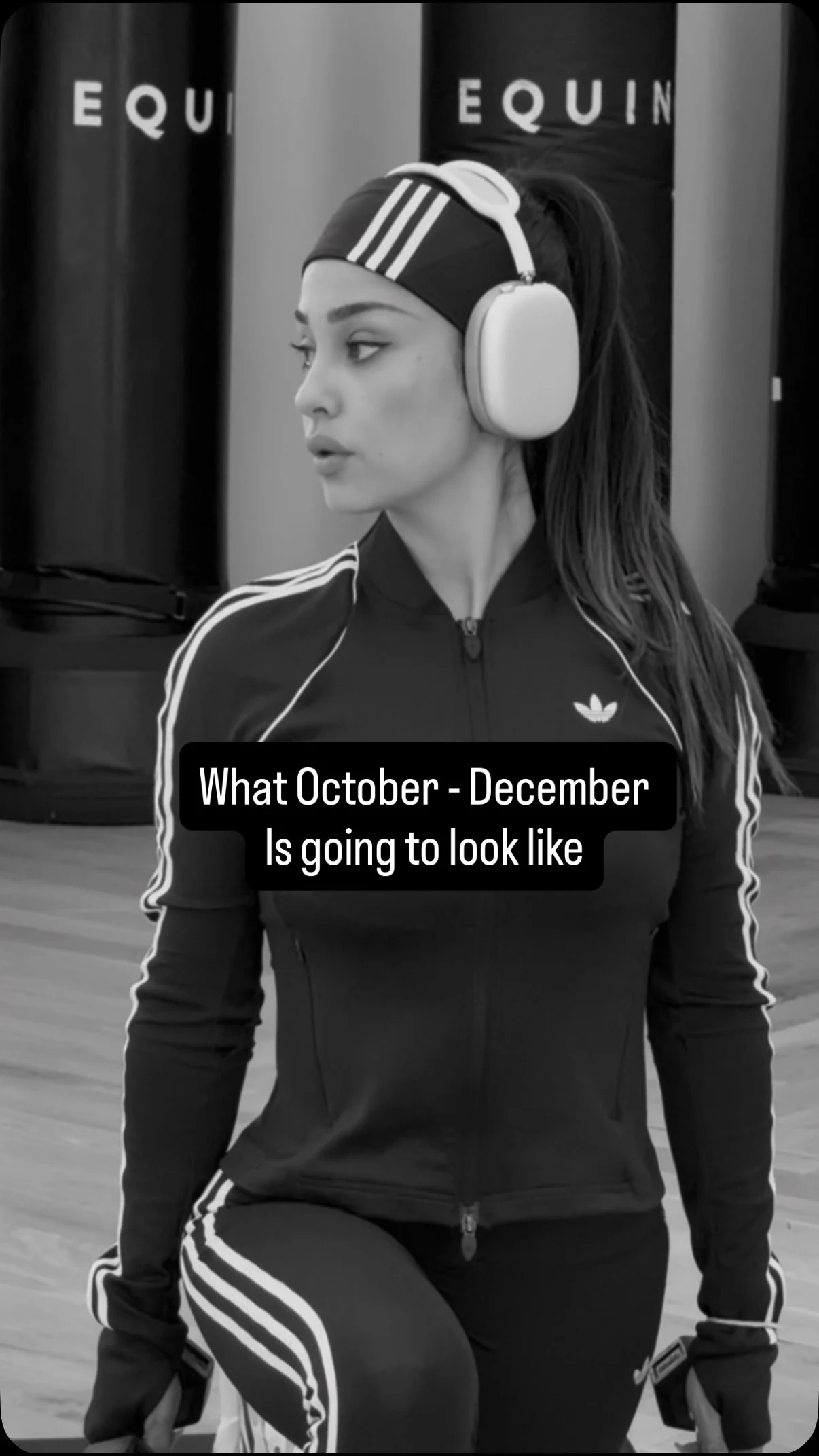 Fitted dark athletic jacket and matching striped leggings worn with a headband and over-ear headphones.