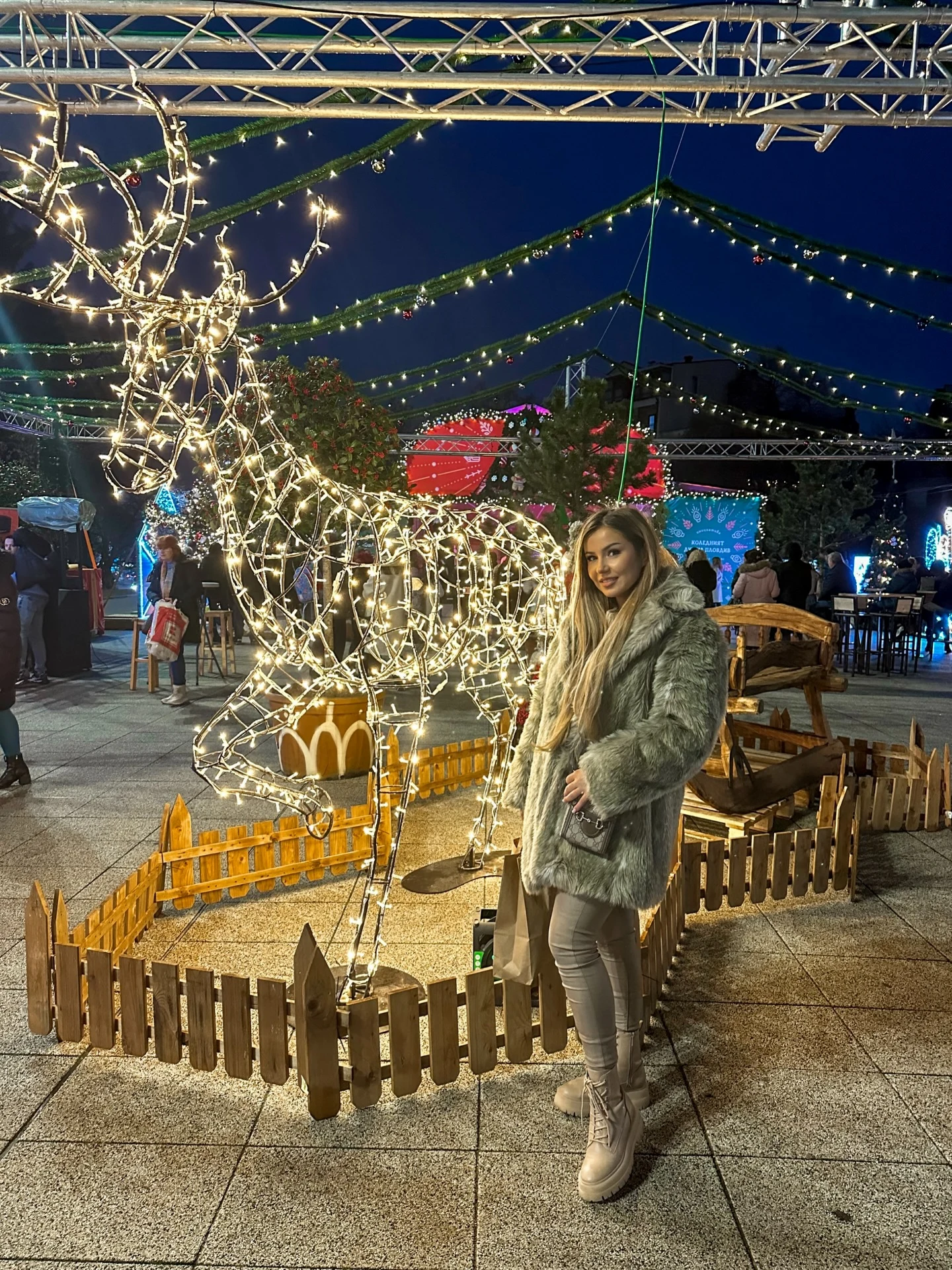 Woman wearing a coordinated light gray faux-fur coat, matching pants, and chunky light boots.