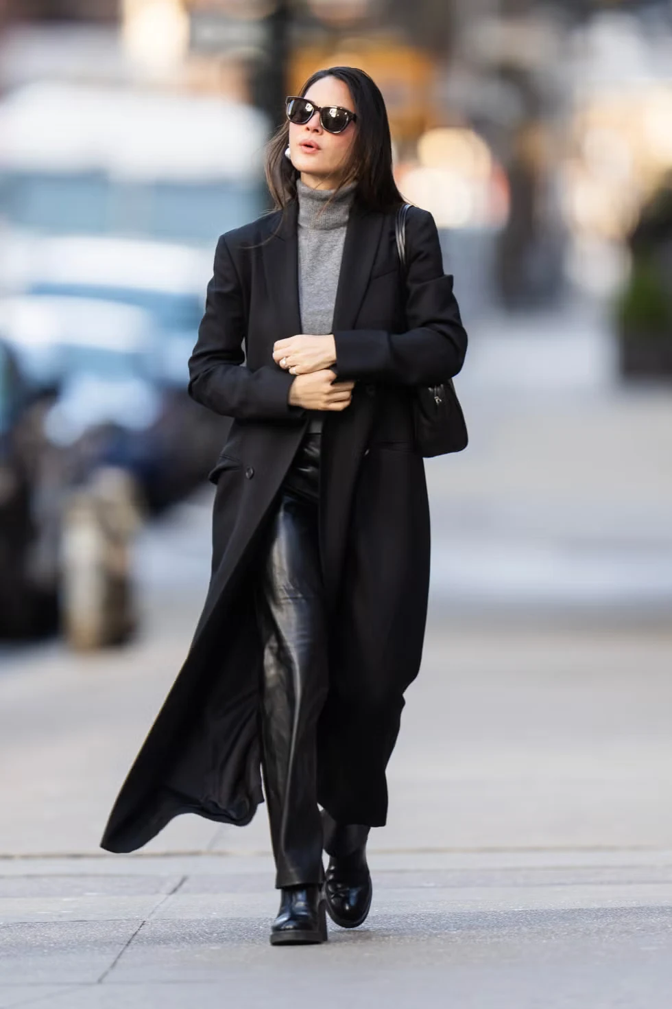 Olivia Munn walking in Tribeca, New York City in a puffer coat and fitted trousers.