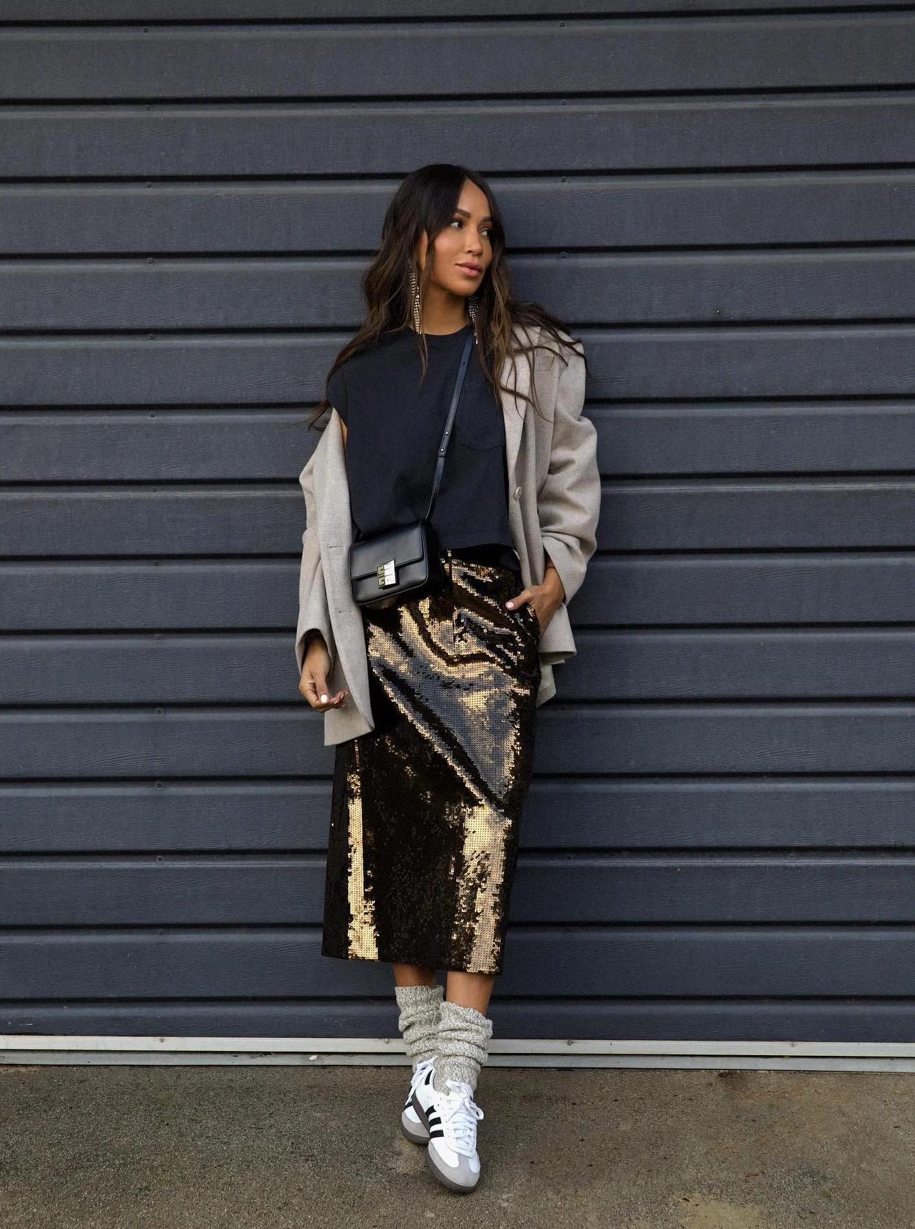 Dark brown sequined midi skirt paired with a black tee, taupe jacket, and white sneakers.