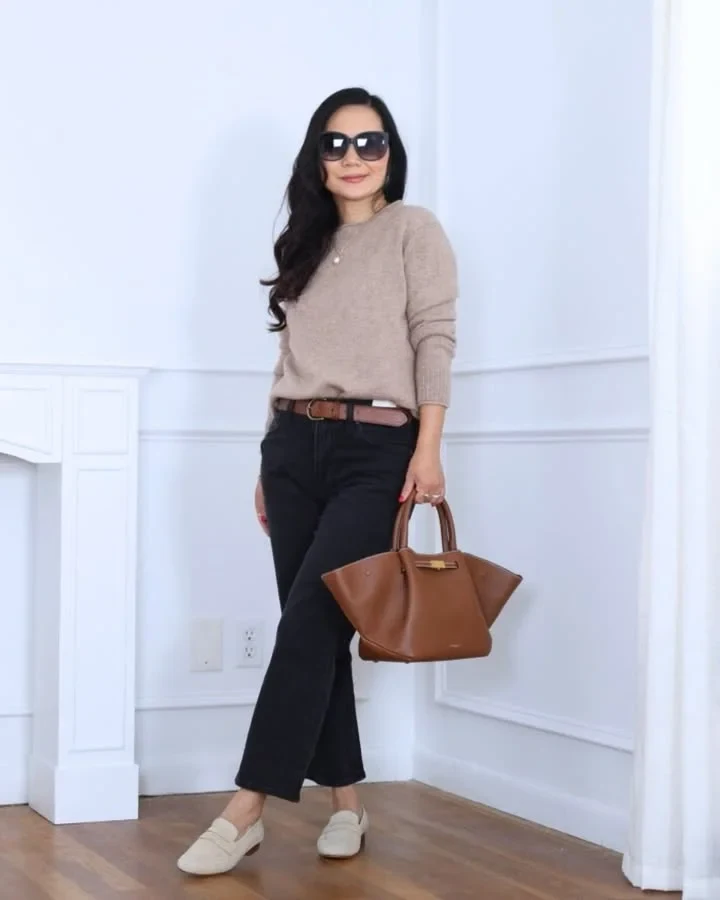Petite woman in a fitted turtleneck and tailored slim trousers styled for winter work.