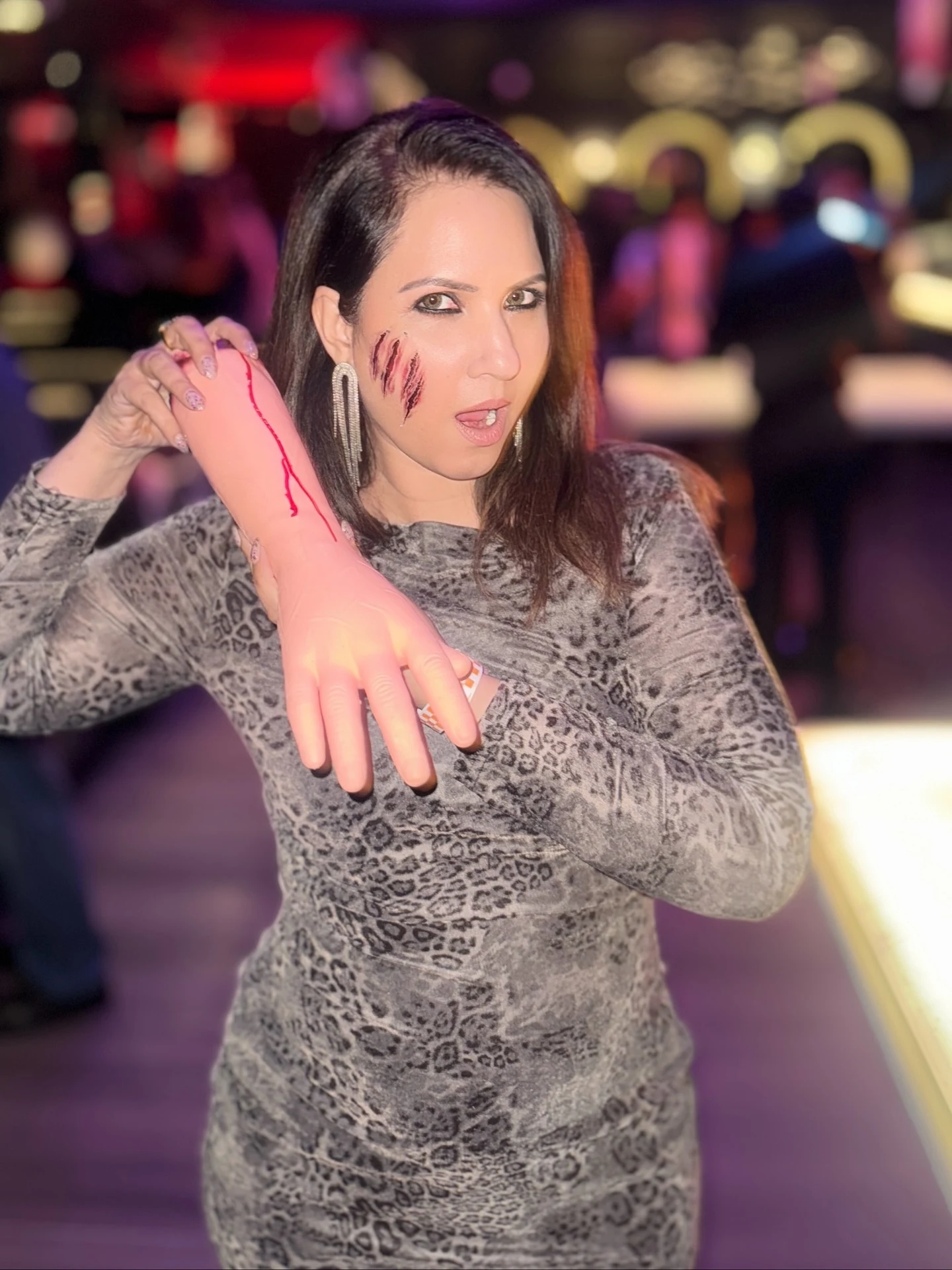 Woman wearing a gray and black leopard print long sleeve midi dress.