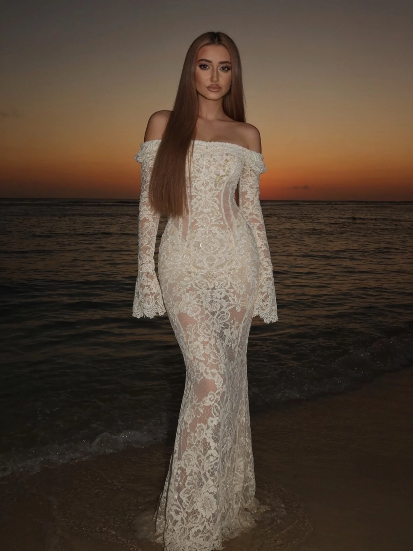 Woman in a white off-the-shoulder lace gown with dramatic long flared sleeves.