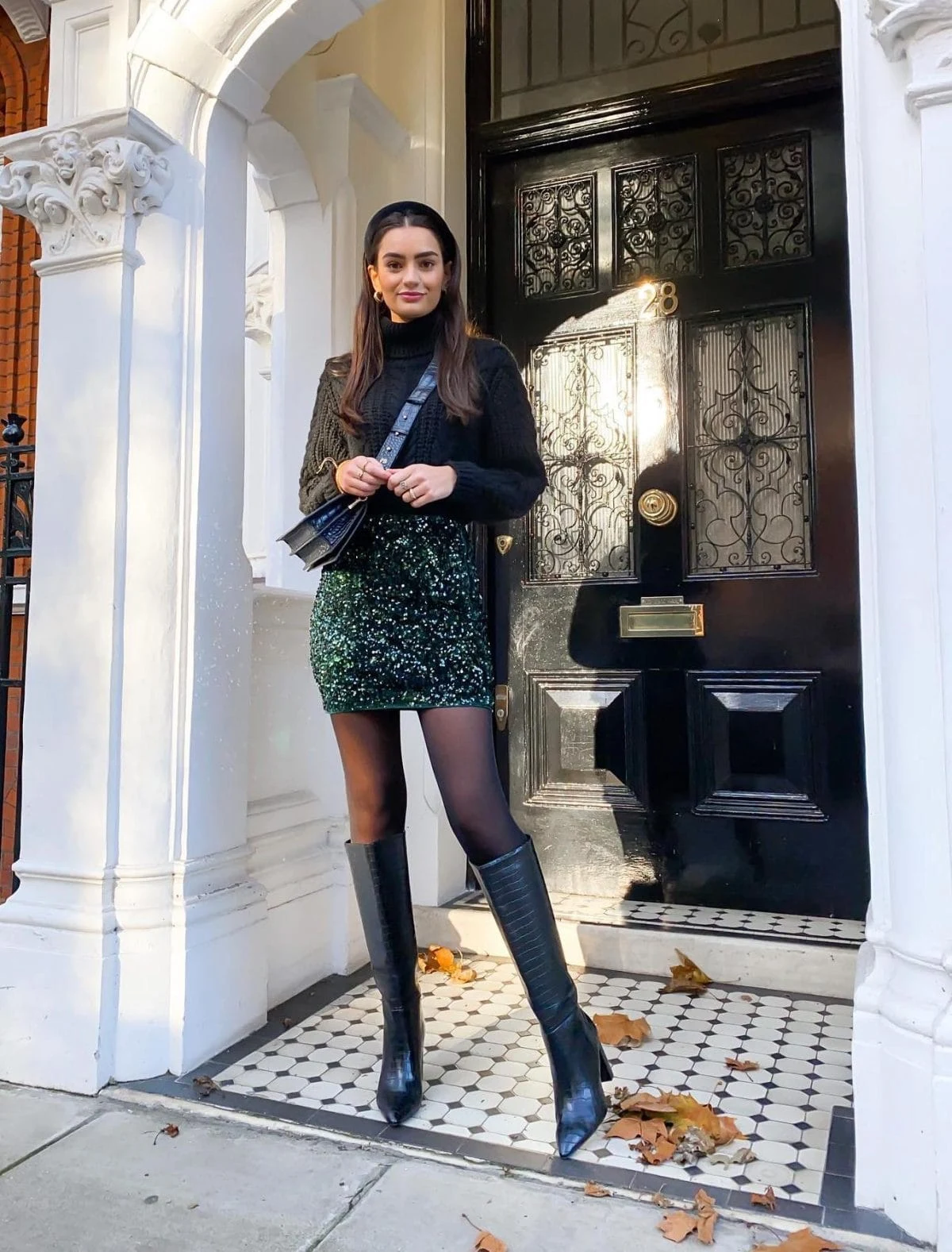 Green sequin skirt paired with dark green cable-knit turtleneck and croc-embossed knee-high boots.
