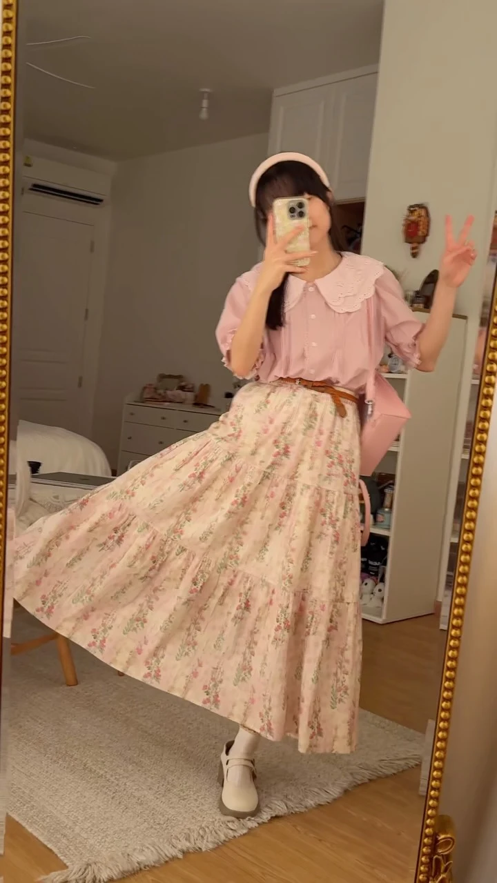 Light pink blouse with lace Peter Pan collar styled with a cream floral midi skirt.