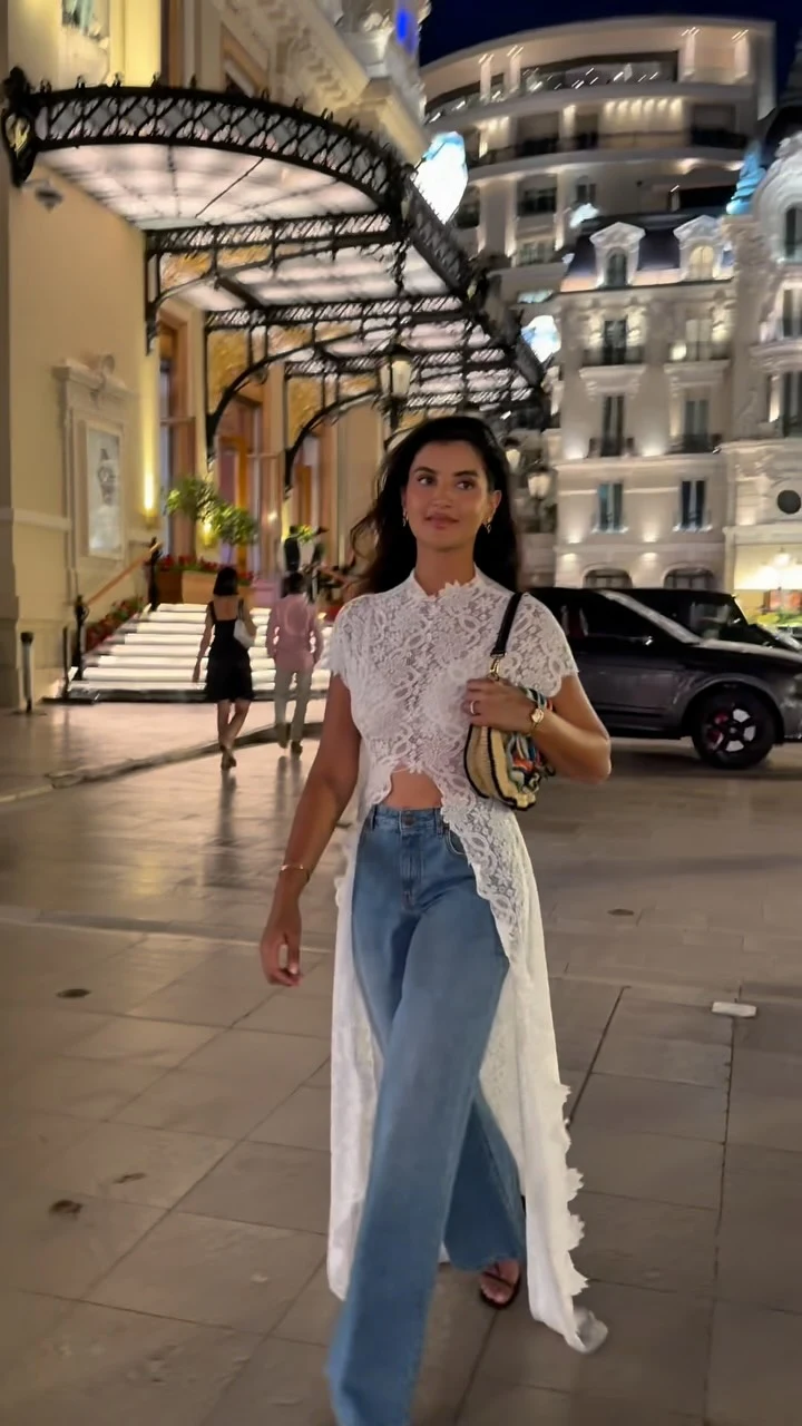 White lace short-sleeve top with long open front panel, high-waisted wide-leg blue jeans