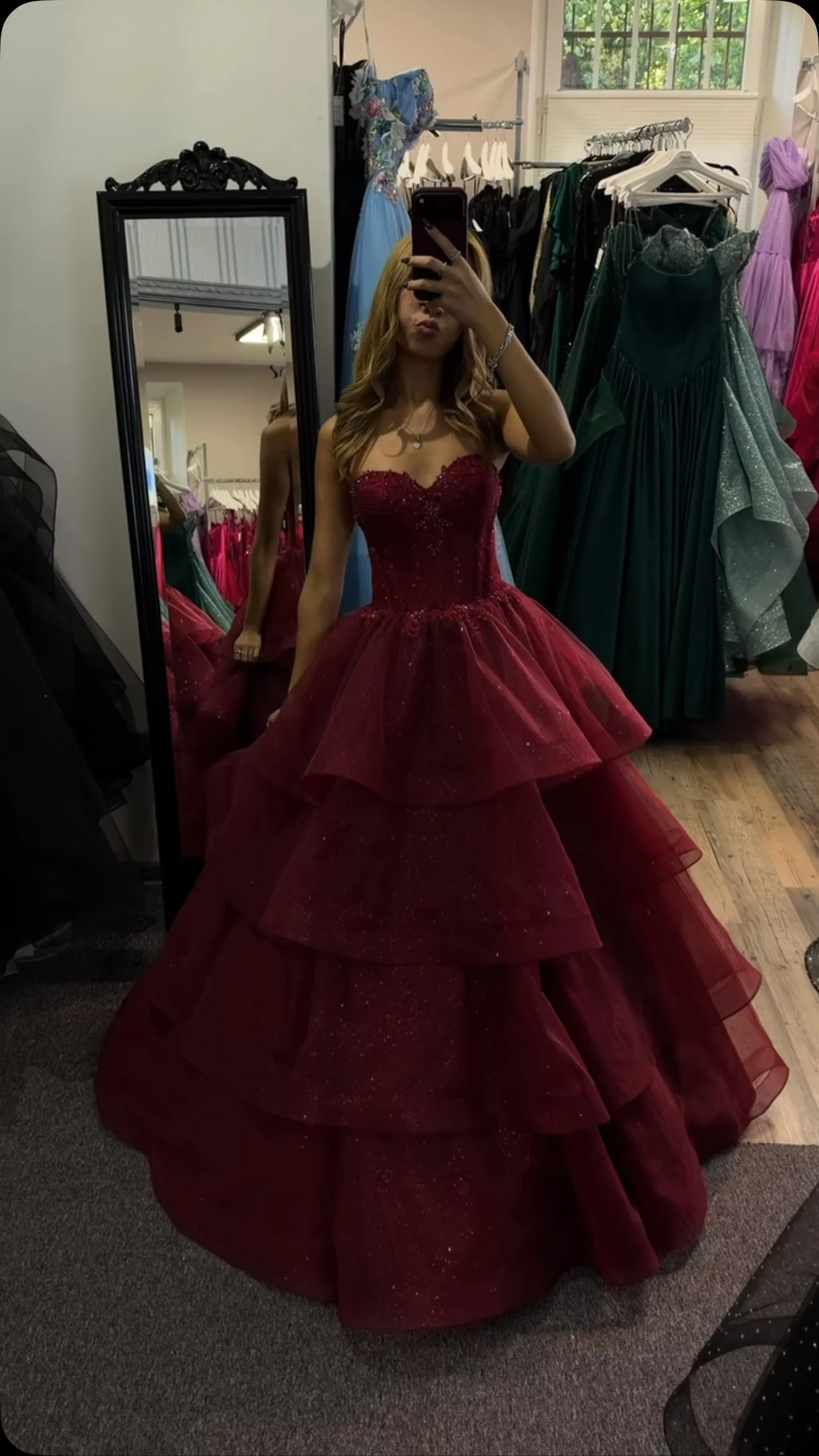 Burgundy strapless ballgown with fitted embellished bodice, sweetheart neckline and multi-tiered glitter tulle skirt