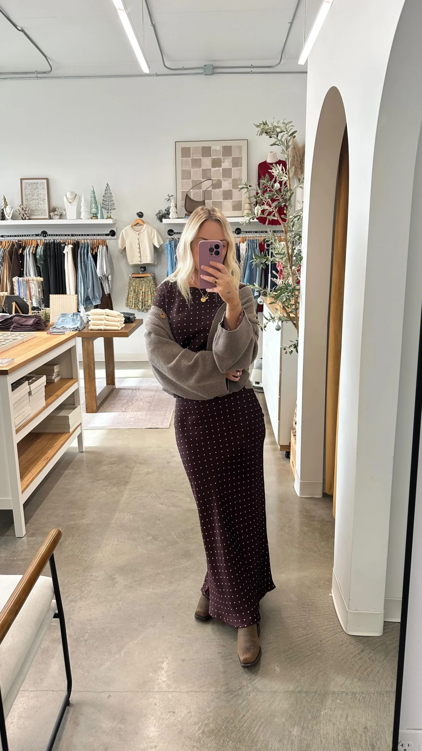 Long dark burgundy polka-dot dress with bell sleeves.