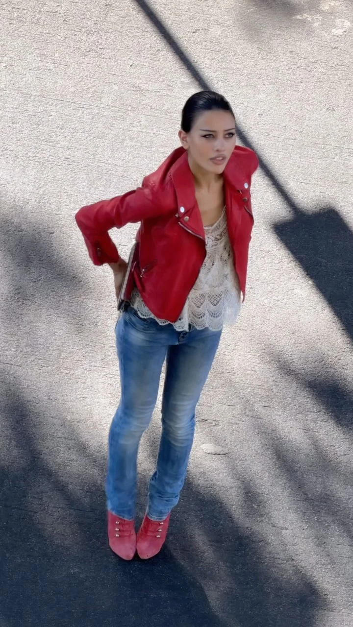 bright red moto jacket, white lace camisole underneath, light-wash flared jeans, matching red ankle boots, small clutch with American flag design
