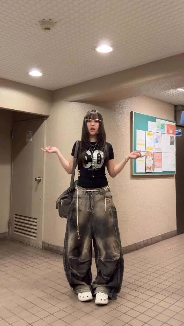 Very baggy dark denim jeans, light gray cropped hoodie over red plaid shirt