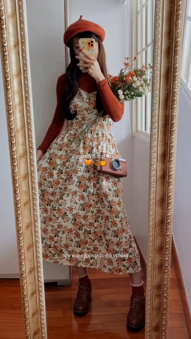 Cream floral midi dress layered over a rust top with beret and brown ankle boots.