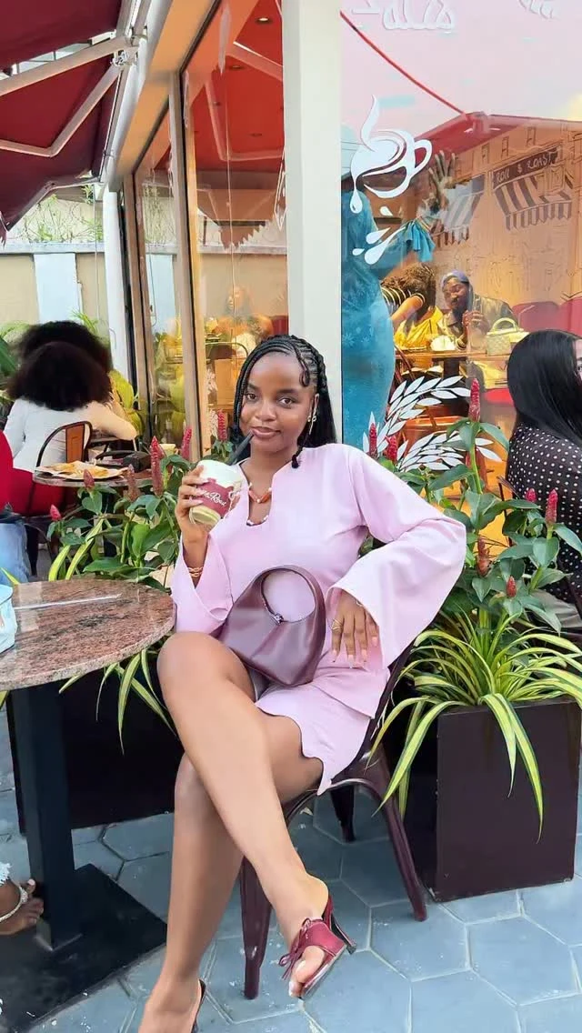 Woman wearing a coordinated light pink bell-sleeve top and scalloped shorts matching set.