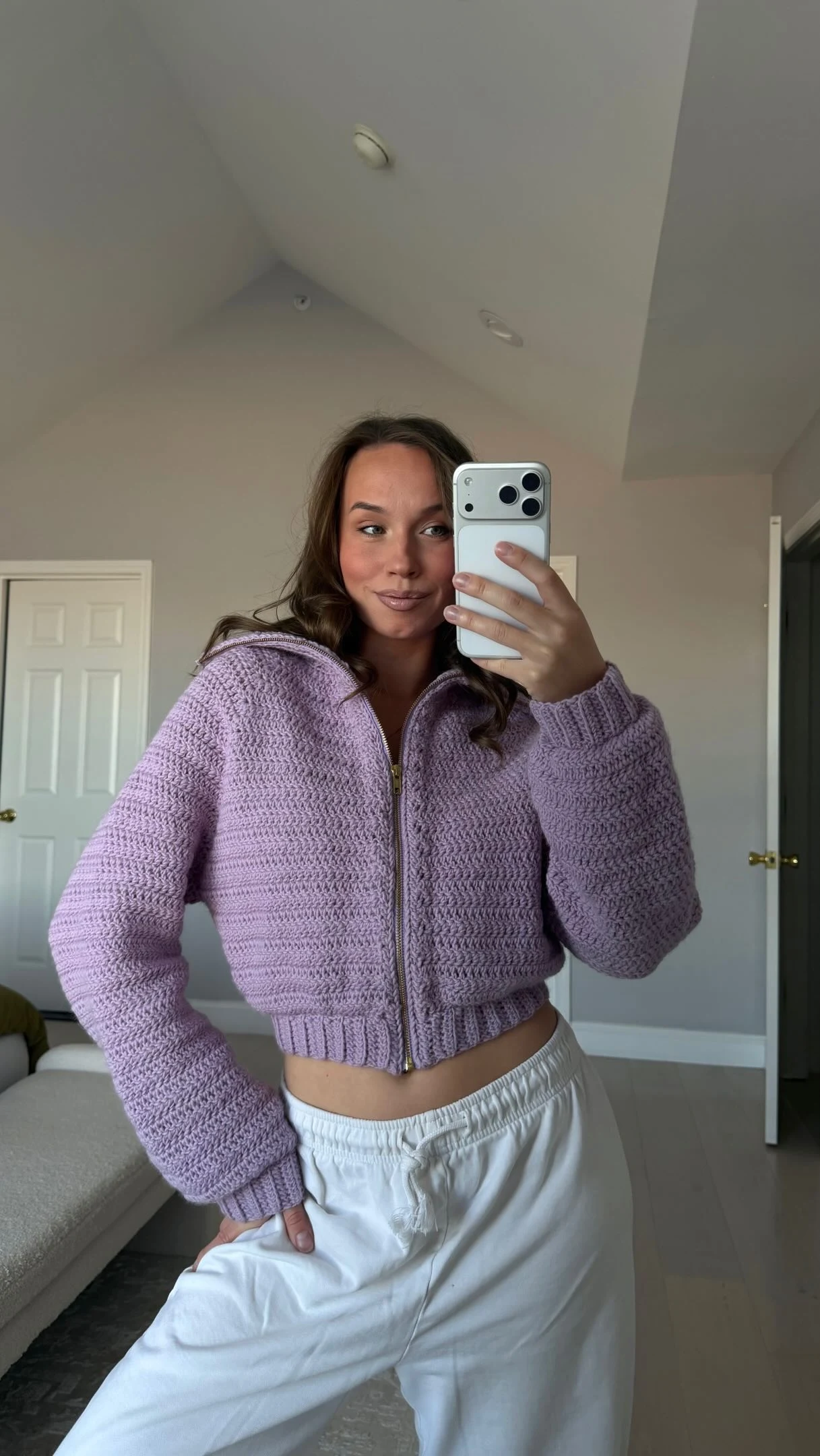 Lilac cropped zip cardigan with chunky texture worn over loose white drawstring pants.