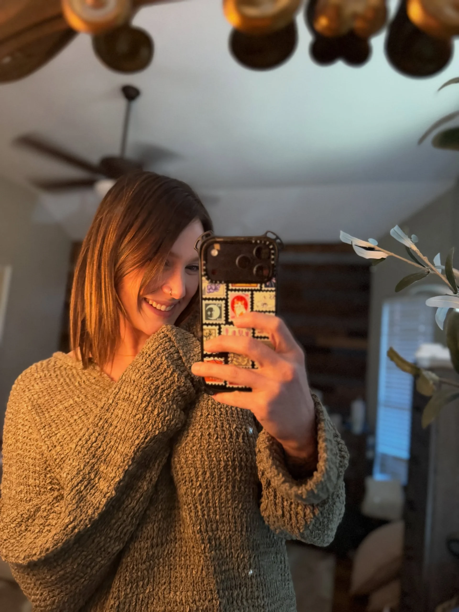 Chunky oversized brown knit sweater with a wide folded neckline that drapes softly across the chest.