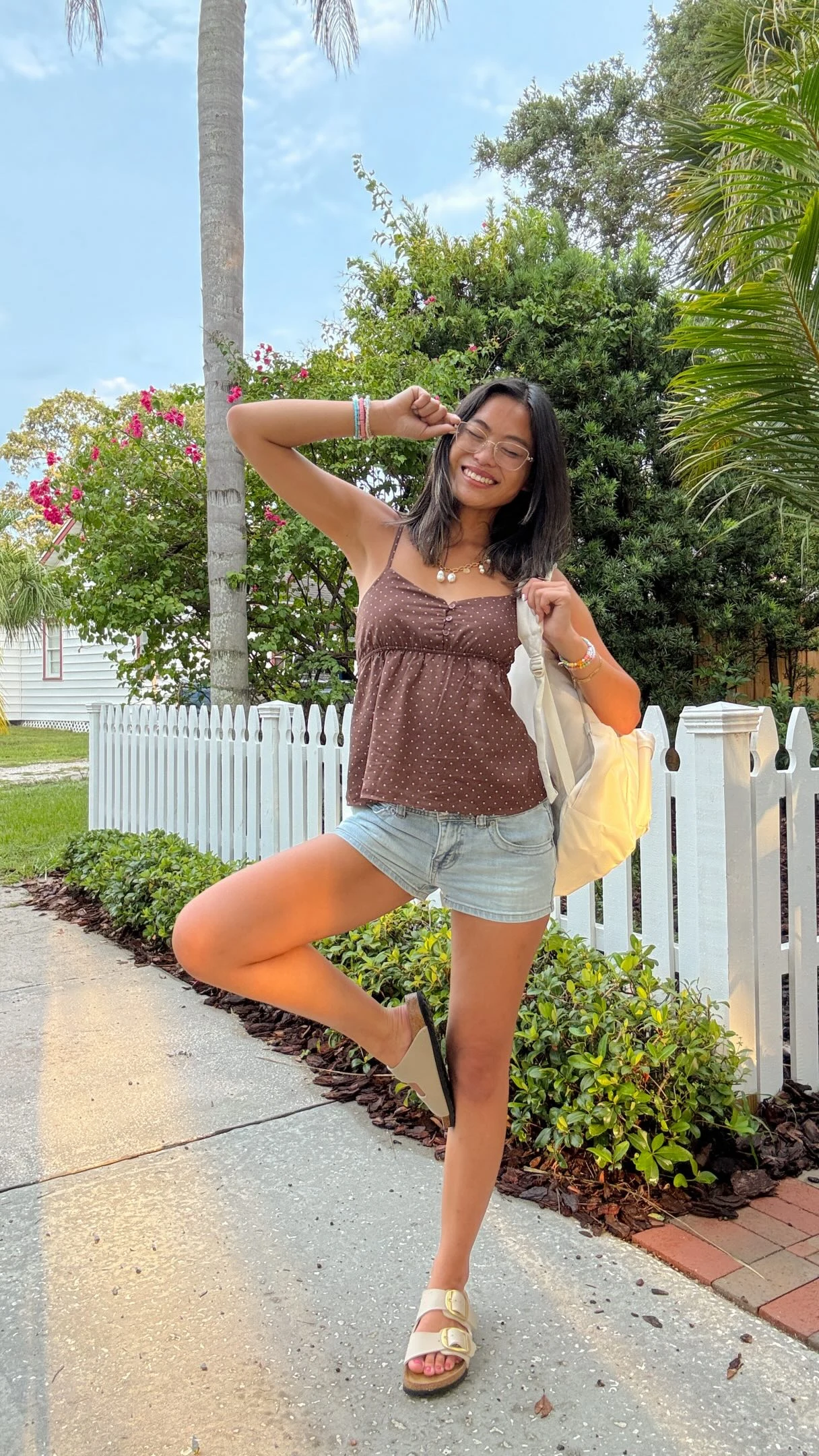 brown spaghetti-strap polka-dot camisole, light-wash denim shorts, white Boston Soft Footbed clogs