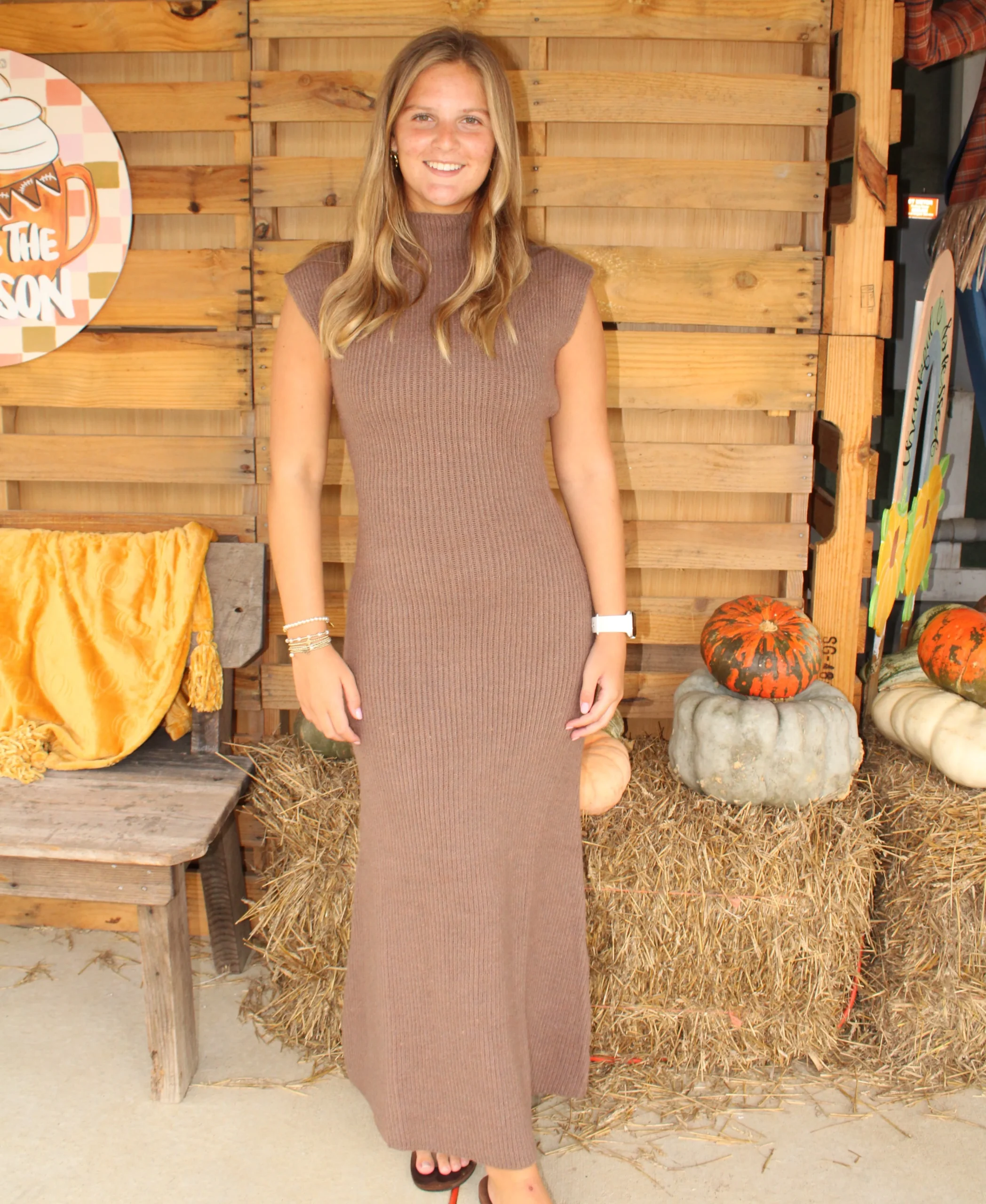Sleeveless high-neck ribbed brown maxi dress that reaches ankles with sandals and bracelets
