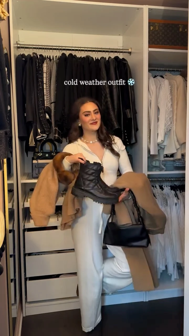 White ribbed zip-up bodysuit, dark brown opaque tights, tan turtleneck sweater dress, long camel wool coat, chunky black combat boots, black leather gloves, brown fuzzy headband, black structured handbag