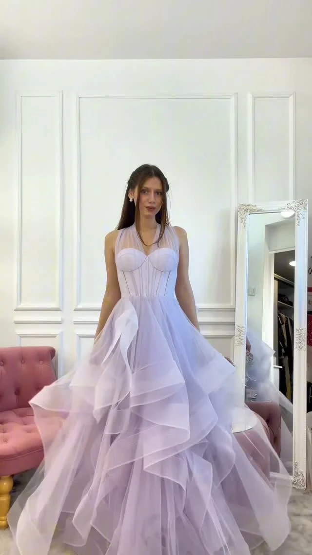 Light lavender ballgown with corset sweetheart bodice, sheer halter straps, and voluminous layered tulle skirt.