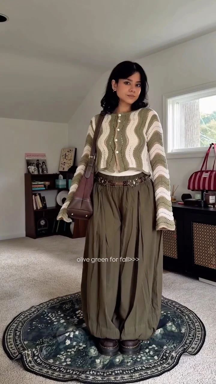 Olive wide-leg trousers styled with a striped cropped cardigan, dark belt, chunky shoes, and mauve bag.
