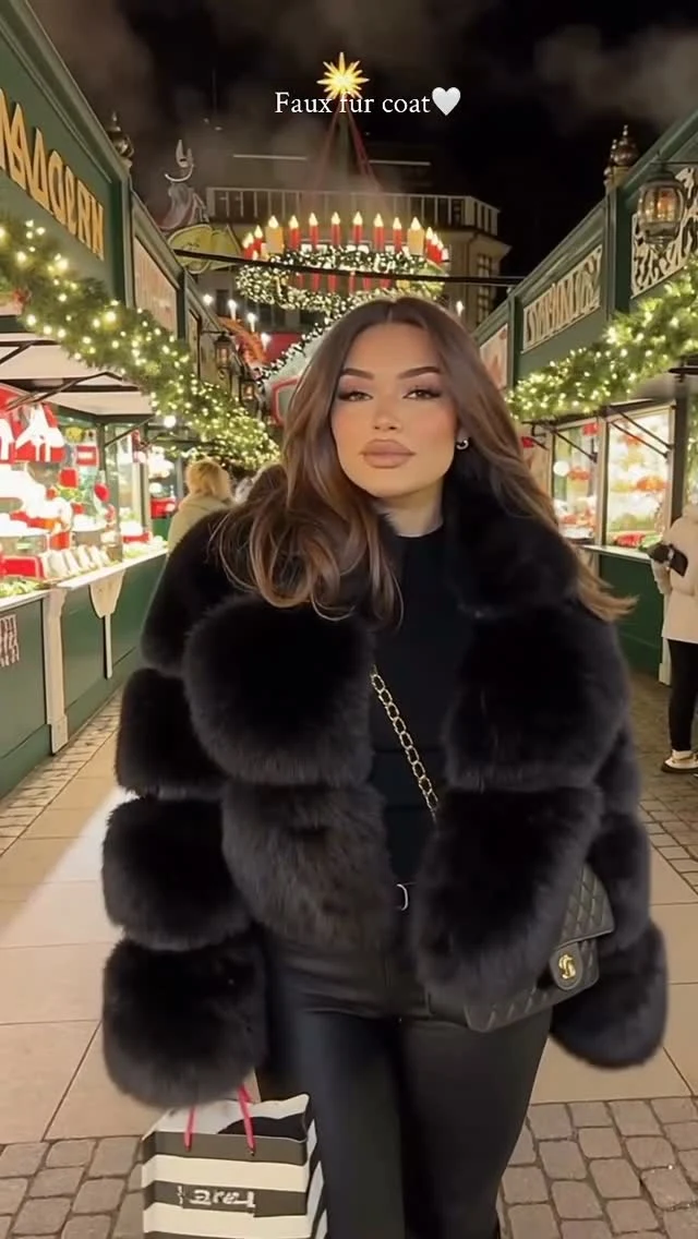 Oversized black faux fur coat over black top, shiny black leggings, black quilted crossbody bag