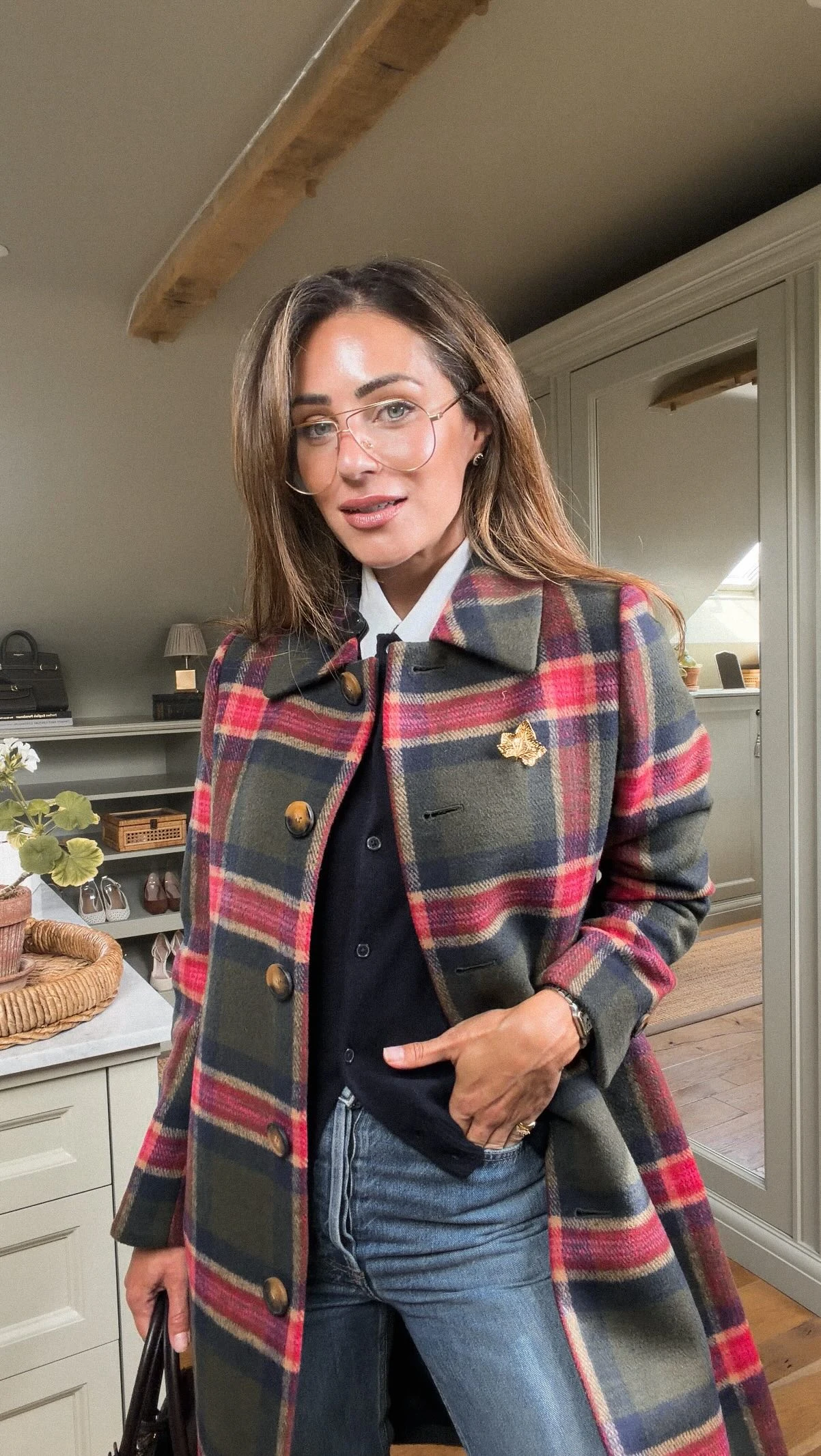 Woman in a black ribbed turtleneck, wide-leg faux-leather trousers, and burgundy pointed heels.