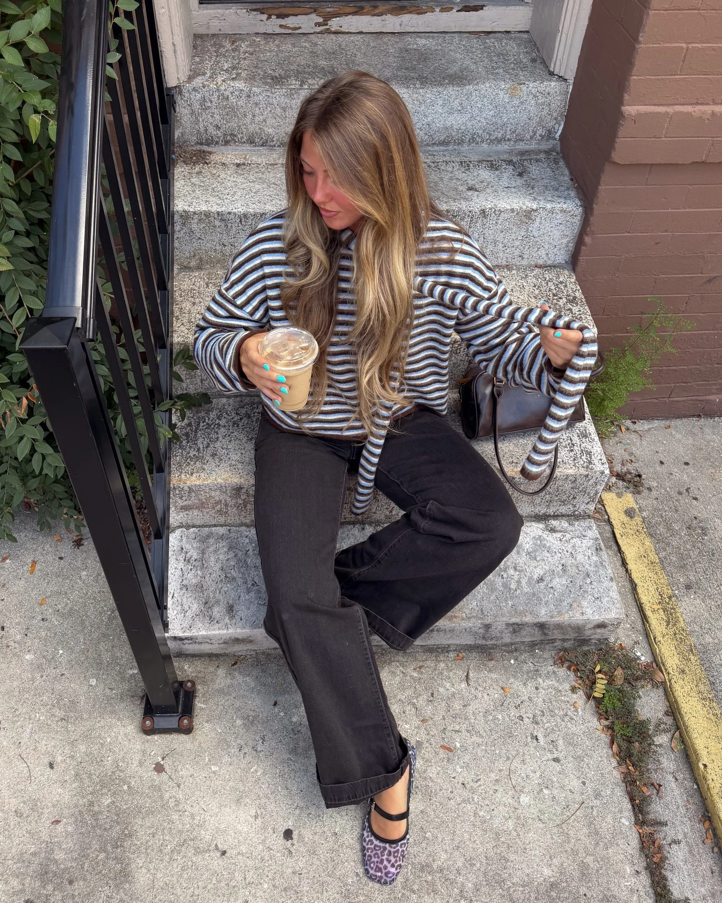 Blue, brown and white striped scarf button-down cardigan with front tie, black wide-leg jeans, leopard-print Mary Jane flats and small brown leather bag