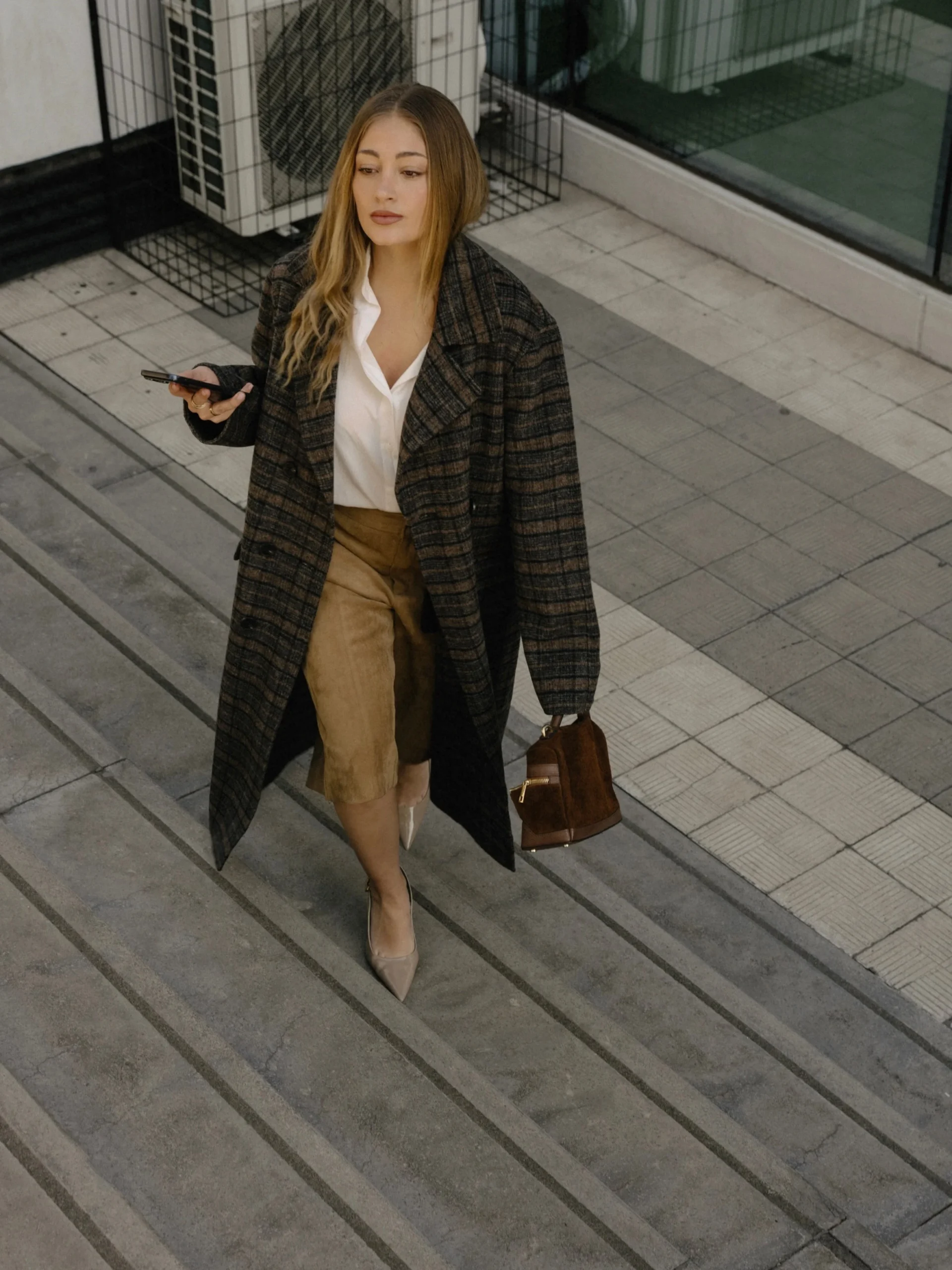 brown plaid double-breasted coat, white button-up shirt, tan suede midi skirt